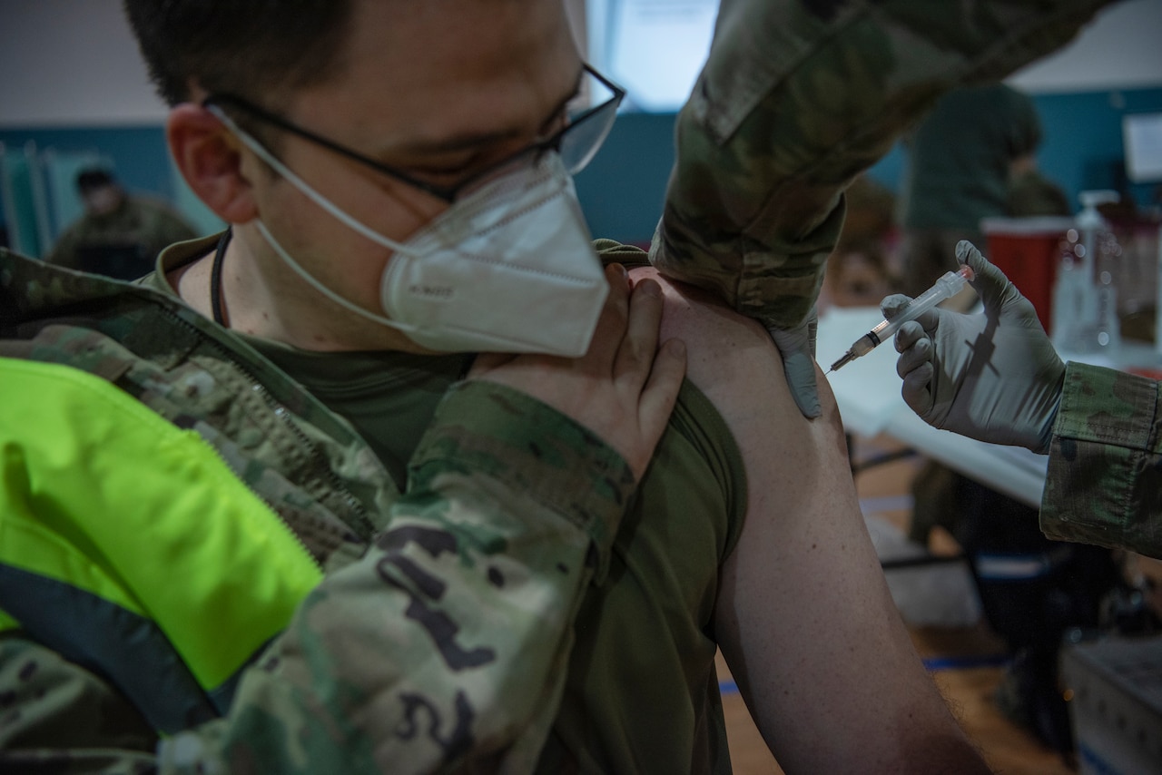 An airman receives a vaccine.