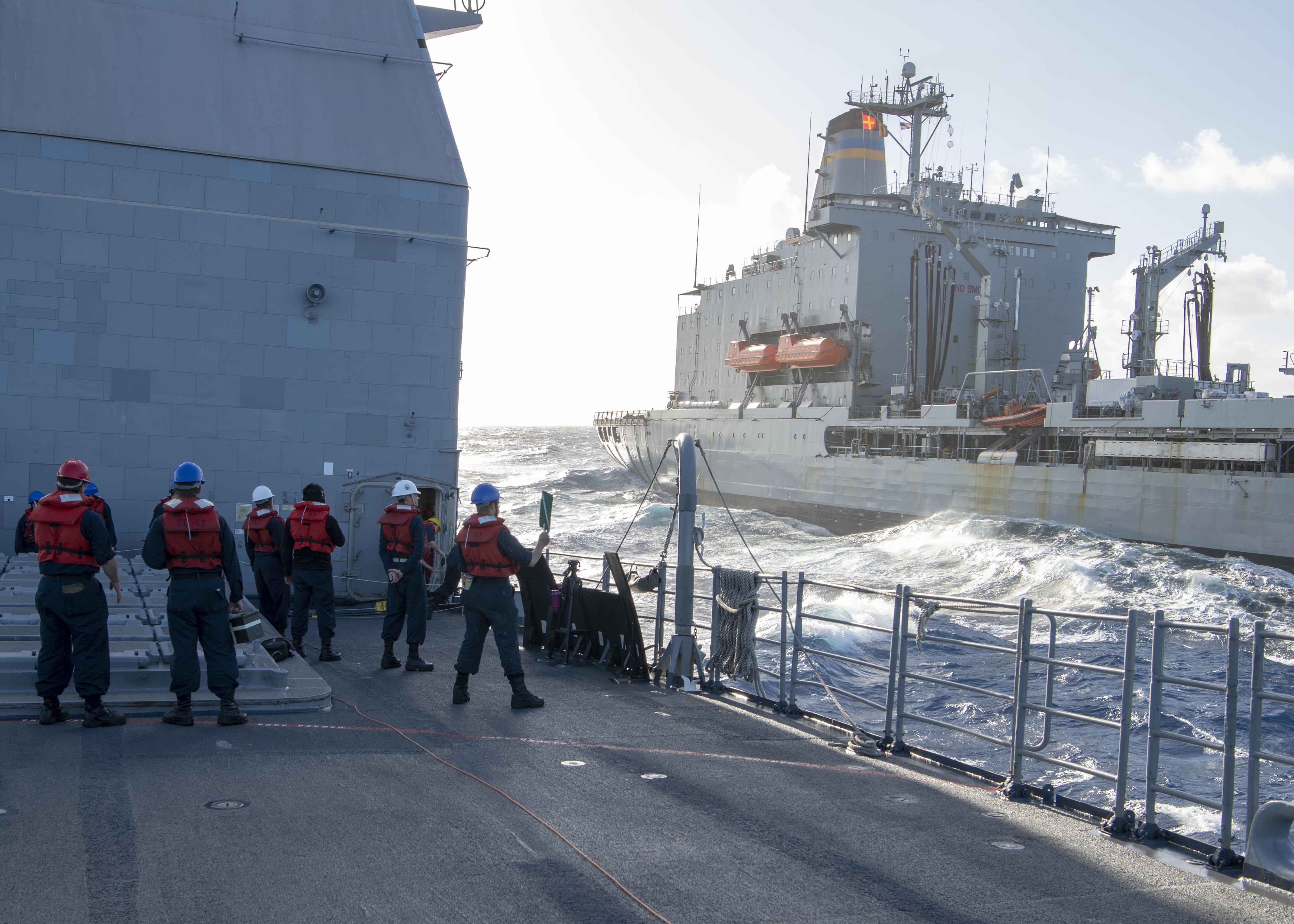 Sailors watch as the Ticonderoga-class guided-missile cruiser USS Bunker Hill (CG 52) approaches the Military Sealift Command fleet replenishment oiler USNS Guadalupe (T-AO 200) for a replenishment-at-sea Jan. 2, 2021.