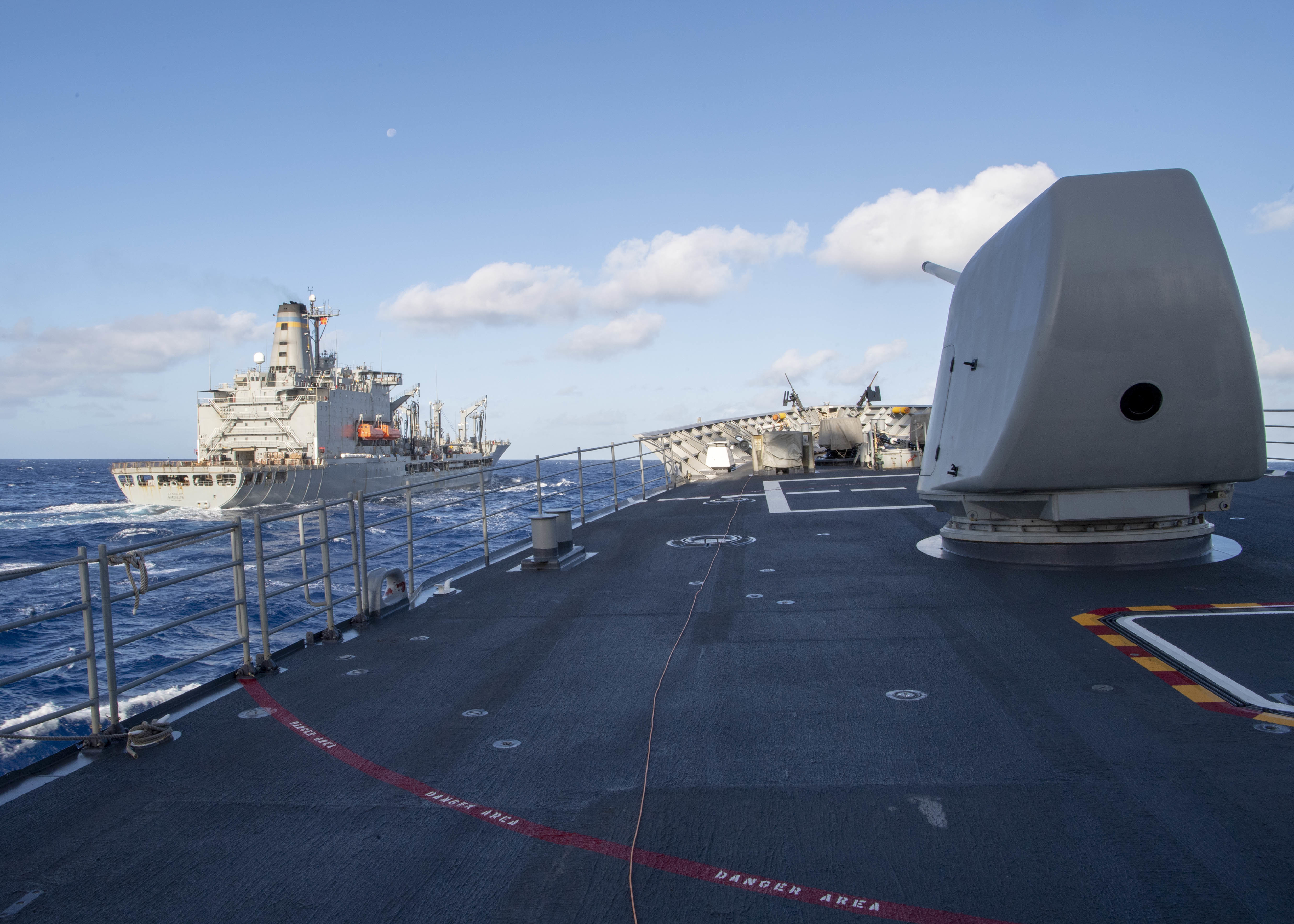 The Ticonderoga-class guided-missile cruiser USS Bunker Hill (CG 52) approaches the Military Sealift Command fleet replenishment oiler USNS Guadalupe (T-AO 200) during a replenishment-at-sea Jan. 2, 2021.