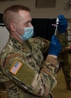 Sgt. Stephen Maynus prepares a dose of COVID-19 vaccine for delivery during a vaccine deployment at Camp Johnson, Vermont, Jan. 4, 2021. Thirty Soldiers and Airmen received vaccinations Jan. 4, with more shots scheduled for Jan. 6 and Jan. 8. Maynus is a health care clinic NCO with the Vermont Army National Guard Medical Detachment.