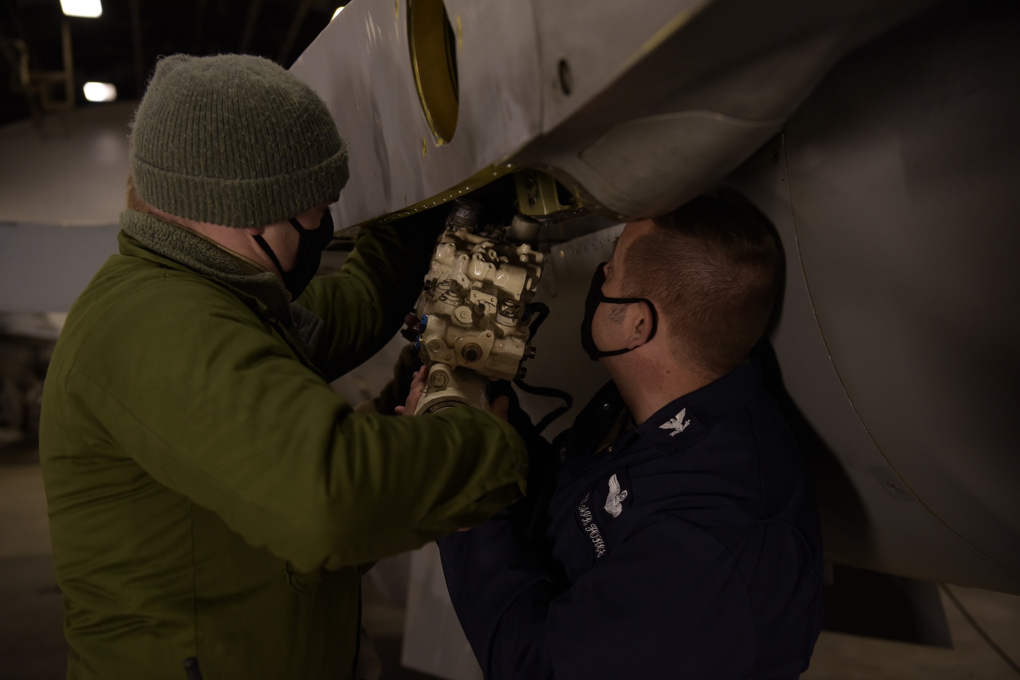 U.S. Air Force Tech. Sgt. Mark Ward, left, a 35th Aircraft Maintenance Squadron dedicated crew chief, instructs Col. Jesse J. Friedel, right, the 35th Fighter Wing commander, how to install a horizontal stabilizer actuator on an F-16 Fighting Falcon during a Wild Weasel Walk-Through at Misawa Air Base, Japan, Dec. 29, 2020. Wild Weasel Walk-Throughs are a weekly event directed by Friedel to learn more about the units he visits and listen to concerns. (U.S. Air Force photo by Airman 1st Class Joao Marcus Costa)