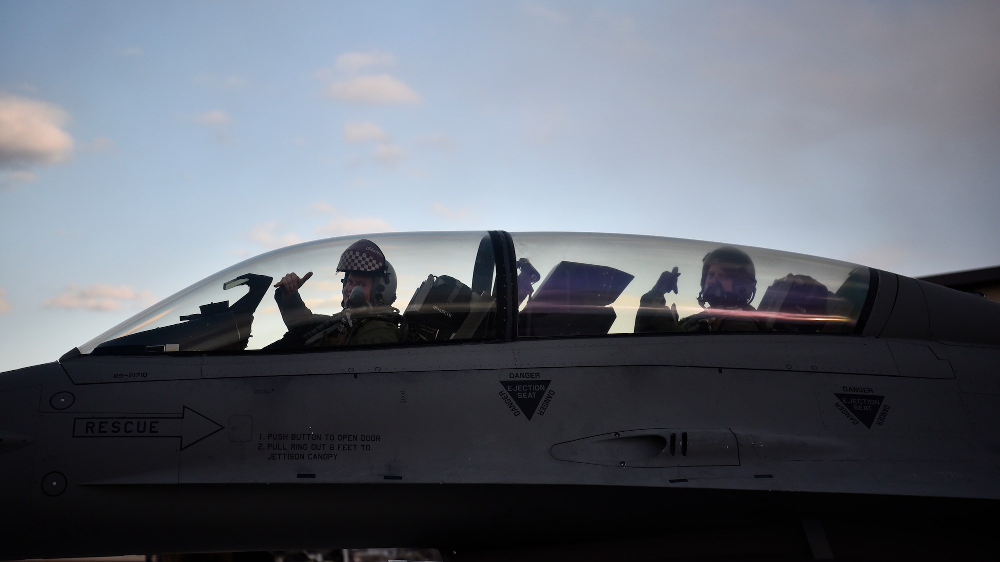 Airmen display their unit's hand sign after a flight.
