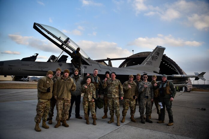 A group of Airmen pose for a photo together.