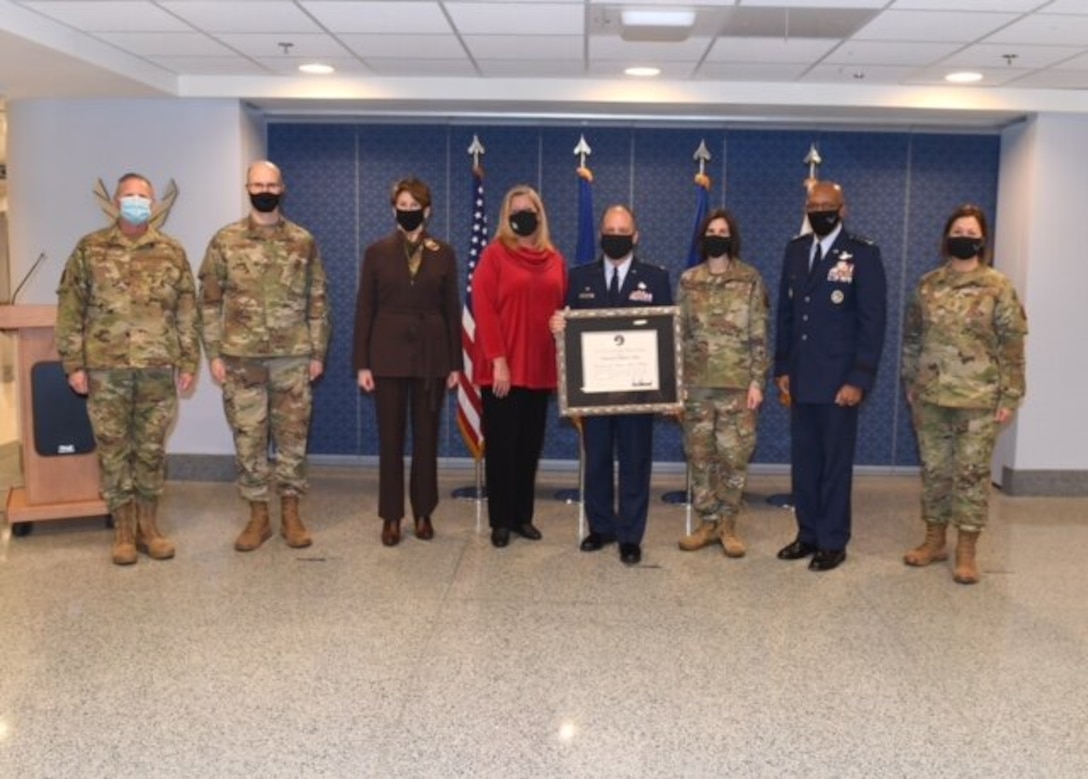 Secretary of the Air Force Barbara Barrett, Chief of Staff of the Air Force General Charles Brown Jr., Chief Master Sergeant of the Air Force JoAnne Bass and various Air Force band members stand with Colonel Don Schofield after he received the National Endowment of the Arts Award during a ceremony in the Pentagon, Washington, D.C., Dec 2, 2020. (US Air Force Photo by Andy Morataya)