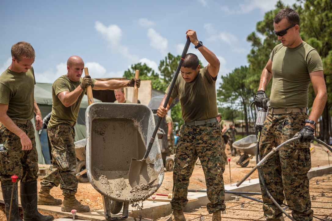 U.S. Marines work together to pour cement into the foundation of the Republica de Cuba School in Puerto Lempira, Honduras, Aug. 17.