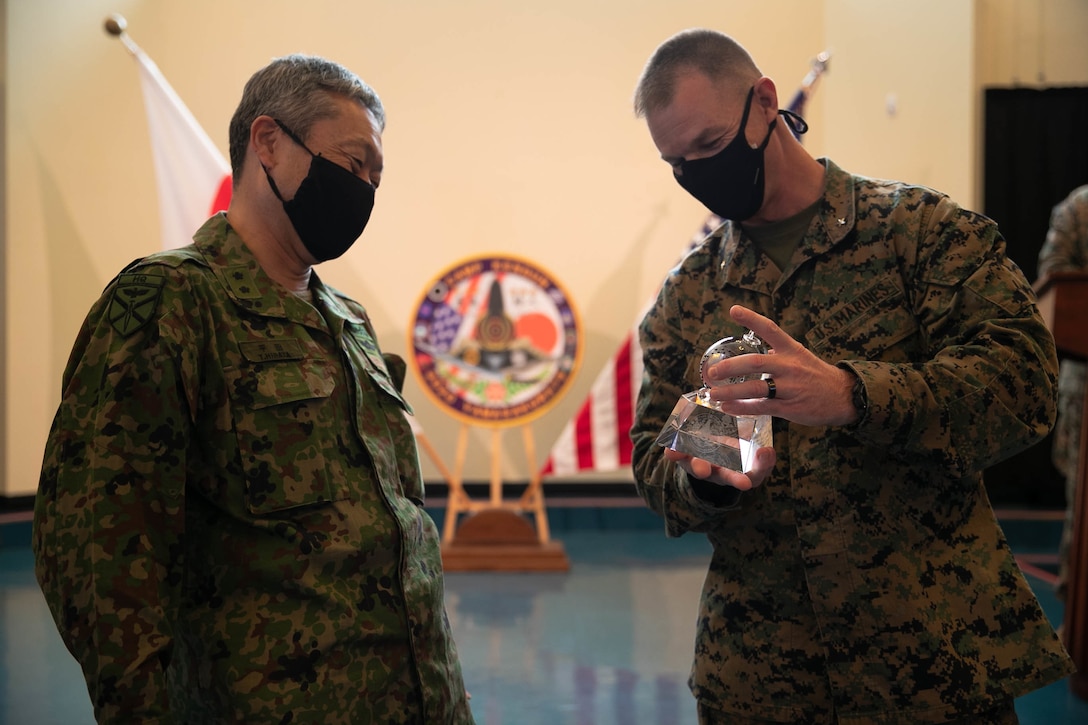 U.S. Marine Corps Brig. Gen. Kyle B. Ellison, commanding general of 3D Marine Expeditionary Brigade, and Maj. Gen. Takanori Hirata recognize service members involved in Exercise Yama Sakura 79 during the closing ceremony on Camp Courtney, Okinawa, Japan, Dec. 14, 2020.