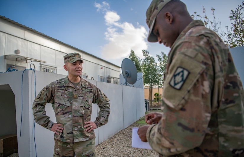 Maj. Elliot Pernula, left, the Staff Judge Advocate for the 75th Field Artillery Brigade, Fort Sill, OK, speaks to Sgt. Kha'lee Gooden, right, the National Security Law Paralegal Non-commissioned officer assigned to the 75th Field Artillery Brigade, the “Diamond Brigade”, of Fort Sill, OK, as he opens a letter received from Col. Tonya Blackwell, the Staff Judge Advocate for the Fires Center of Excellence and Fort Sill, while he is deployed to the Middle East in support of Operation Spartan Shield and Operation Inherent Resolve, December 15, 2020. Sgt. Gooden has continued to demonstrate outstanding leadership both within and outside of the Diamond Brigade. (U.S. Army photo by Sgt. Dustin D. Biven / 75th Field Artillery Brigade)