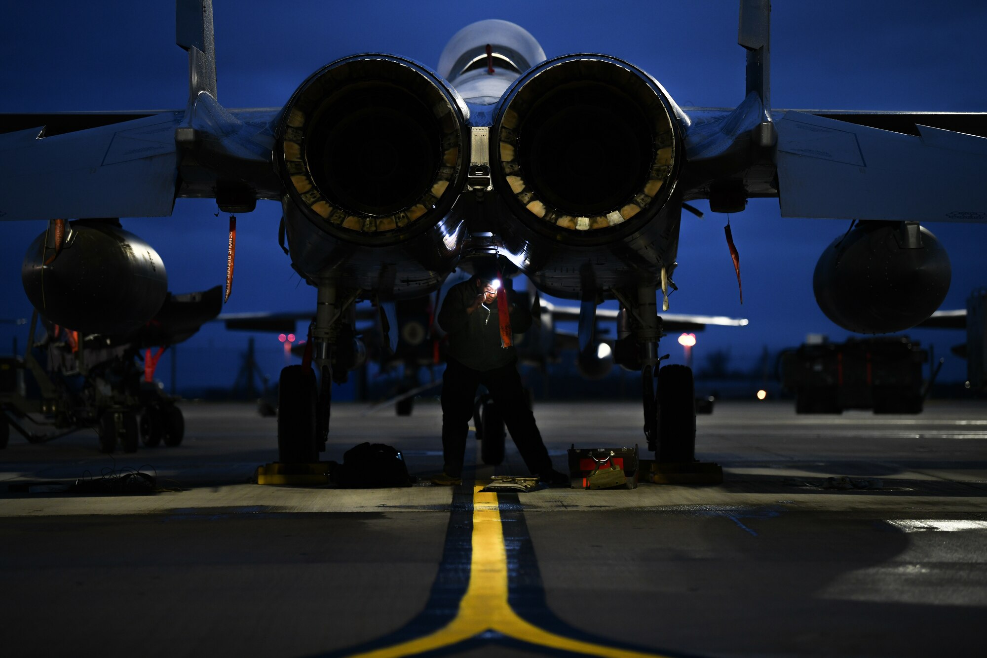 Staff Sgt. Brandon Thomas-Volkov, 494th Aircraft Maintenance Unit dedicated crew chief, inspects the underside of an F-15E Strike Eagle before the first takeoffs of the new year at Royal Air Force Lakenheath, England, Jan. 5, 2021. Dedicated Crew Chiefs are responsible for managing and supervising all maintenance on their respective aircraft by coordinating with other maintenance specialties such as propulsion, hydraulics and fuels to ensure the aircraft is operational in a timely manner. (U.S. Air Force photo by Senior Airman Madeline Herzog)