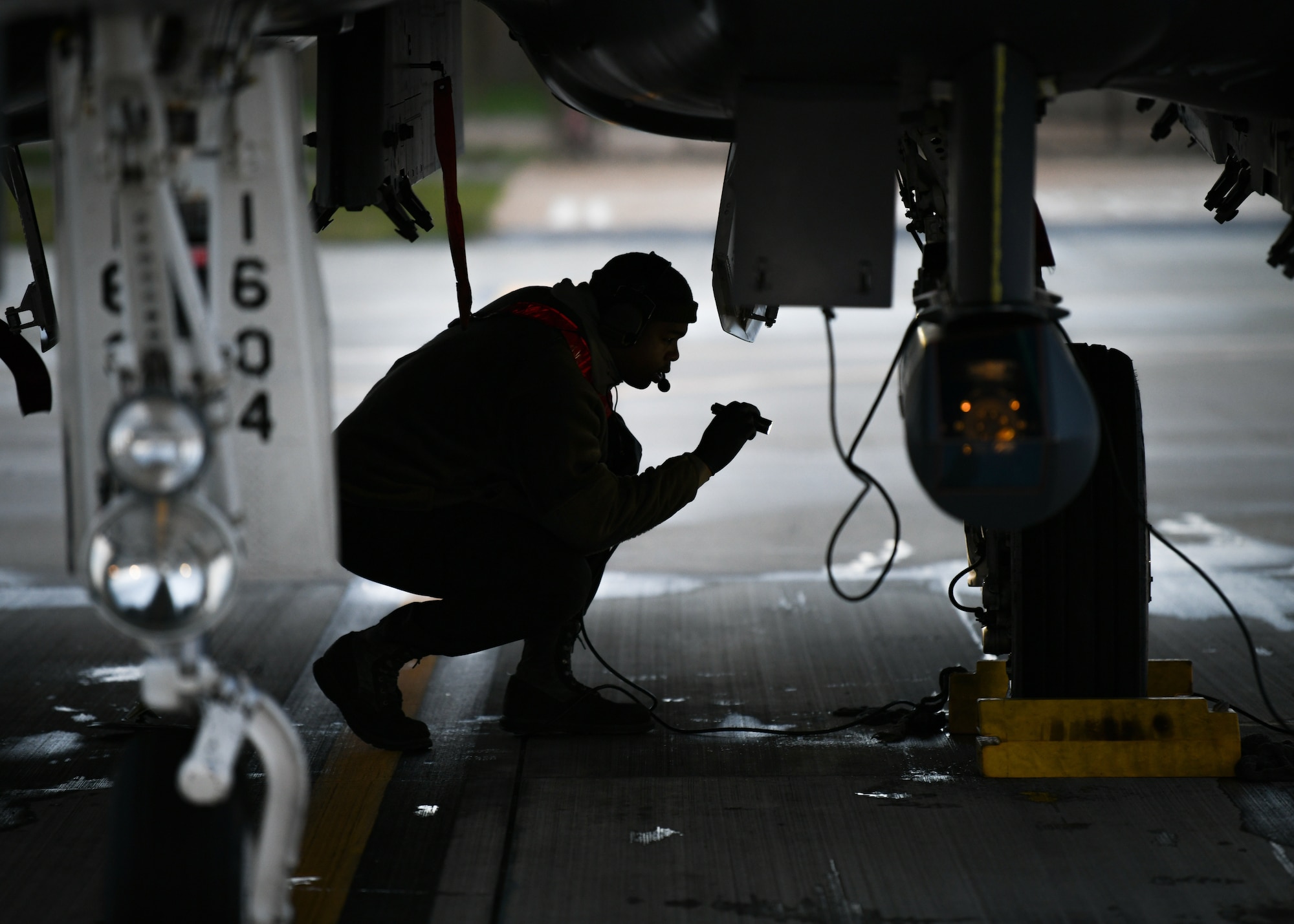 Staff Sgt. Virgil Lawson Jr., 494th Aircraft Maintenance Unit dedicated crew chief, inspects the wheels of an F-15E Strike Eagle before the first takeoffs of the new year at Royal Air Force Lakenheath, England, Jan. 5, 2021. Dedicated Crew Chiefs are responsible for managing and supervising all maintenance on their respective aircraft by coordinating with other maintenance specialties such as propulsion, hydraulics and fuels to ensure the aircraft is operational in a timely manner. (U.S. Air Force photo by Senior Airman Madeline Herzog)