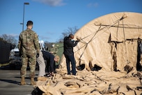 Joint Task Force Civil Support members secure a command post tent as part of an equipment check in preparation for the command’s upcoming exercise Sudden Response 21.