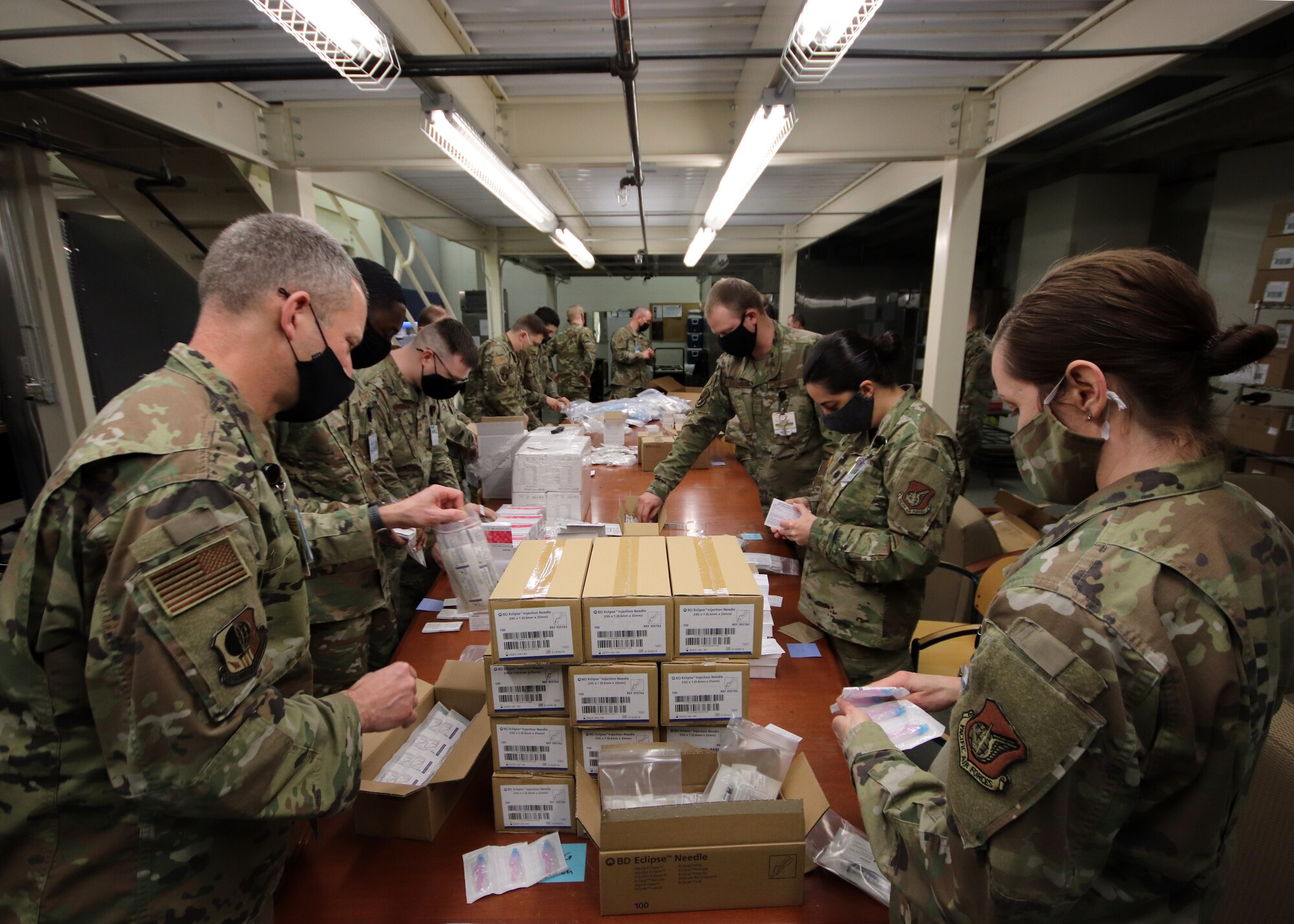U.S. Airmen with the 673d Medical Group prepare supplies to administer the COVID-19 vaccine at Joint Base Elmendorf-Richardson, Alaska, Dec. 30, 2020. Upon receiving the initial shipment of the vaccine, JBER began inoculating personnel following the Centers for Disease Control and Prevention’s prioritization guidelines. The vaccine is part of Operation Warp Speed, a national initiative to accelerate the development, production and distribution of safe and effective COVID-19 vaccines, therapeutics and diagnostics.