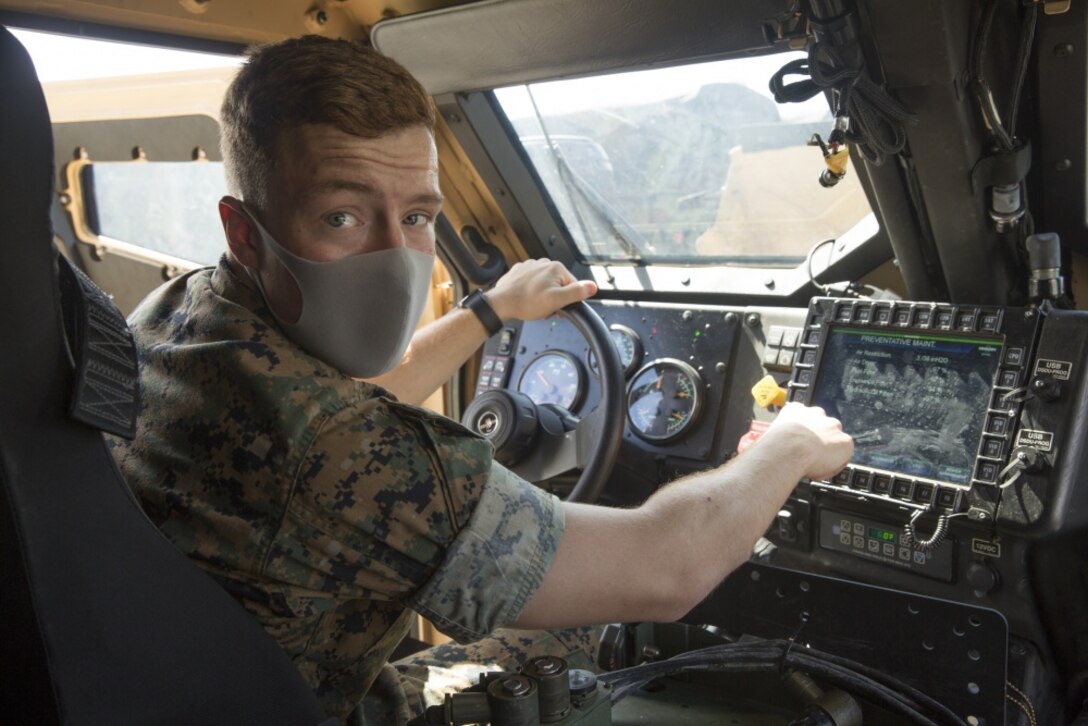 U.S. Marine Lance Cpl. Evan M. Simonds, a motor transport operator with Truck Co., Headquarters Bn., 3rd Marine Division, demonstrates diagnostic features on the touch screen Driver Side Display Unit (DSDU) on Camp Hansen, Okinawa, Japan, Sept. 18, 2020. The module allows Marines to quickly identify mechanical issues on the Joint Light Tactical Vehicle (JLTV). This capability reduces maintenance hours while increasing reliability. (U.S. Marine Corps photo by Gunnery Sgt. Jacob H. Harrer)