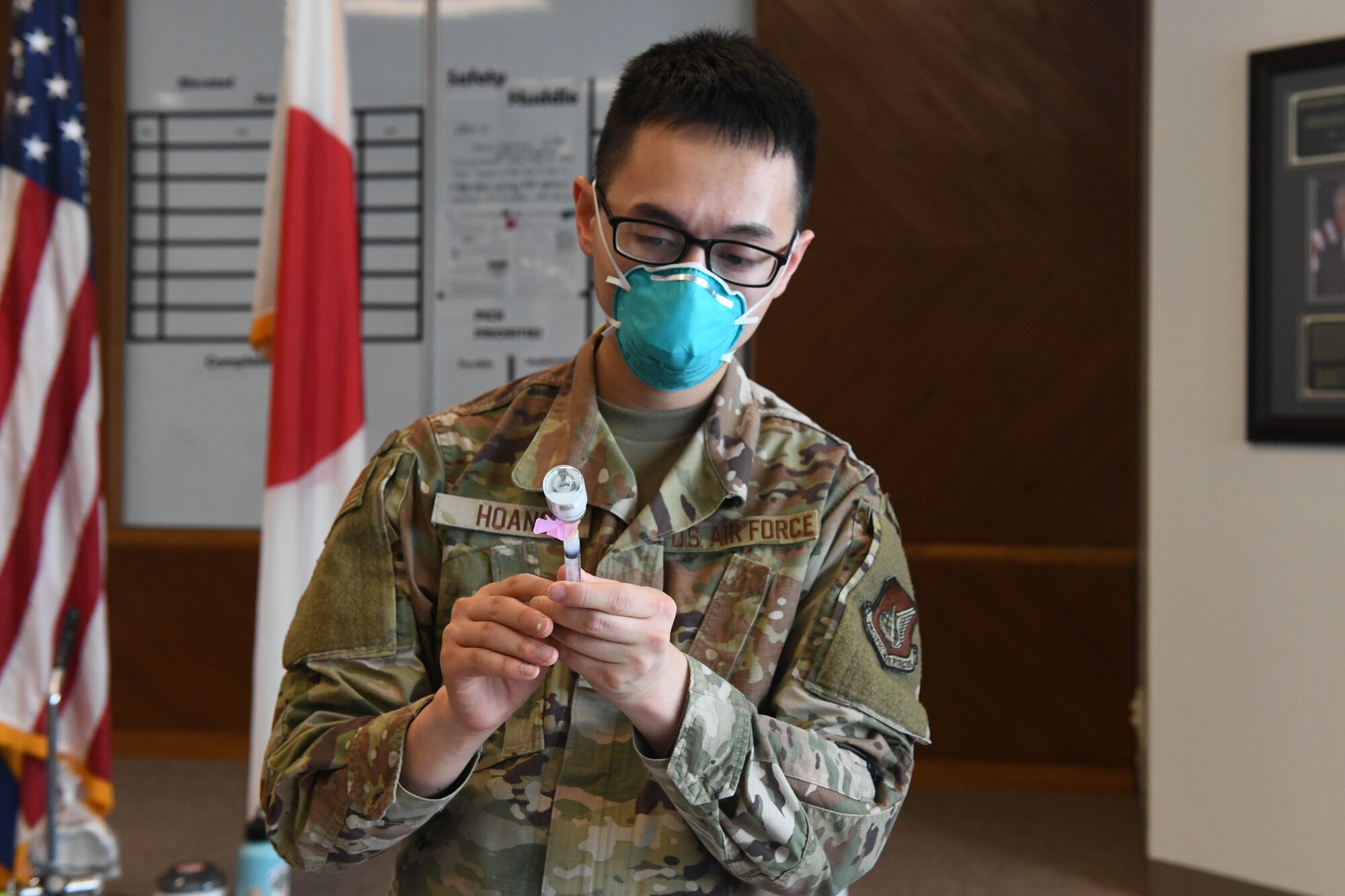 U.S. Air Force Tech. Sgt. David Hoang, an allergy and immunizations technician with the 18th Healthcare Operations Squadron, draws the Moderna’s vaccine into a syringe at Kadena Air Base, Japan, Dec. 28, 2020. As part of DoD’s strategy for prioritizing, distributing and administering the COVID-19 vaccine, those providing direct medical care and emergency services will be prioritized to receive the vaccine at units based in Japan, including Kadena AB. (U.S. Air Force photo by Airman 1st Class Yosselin Perla)