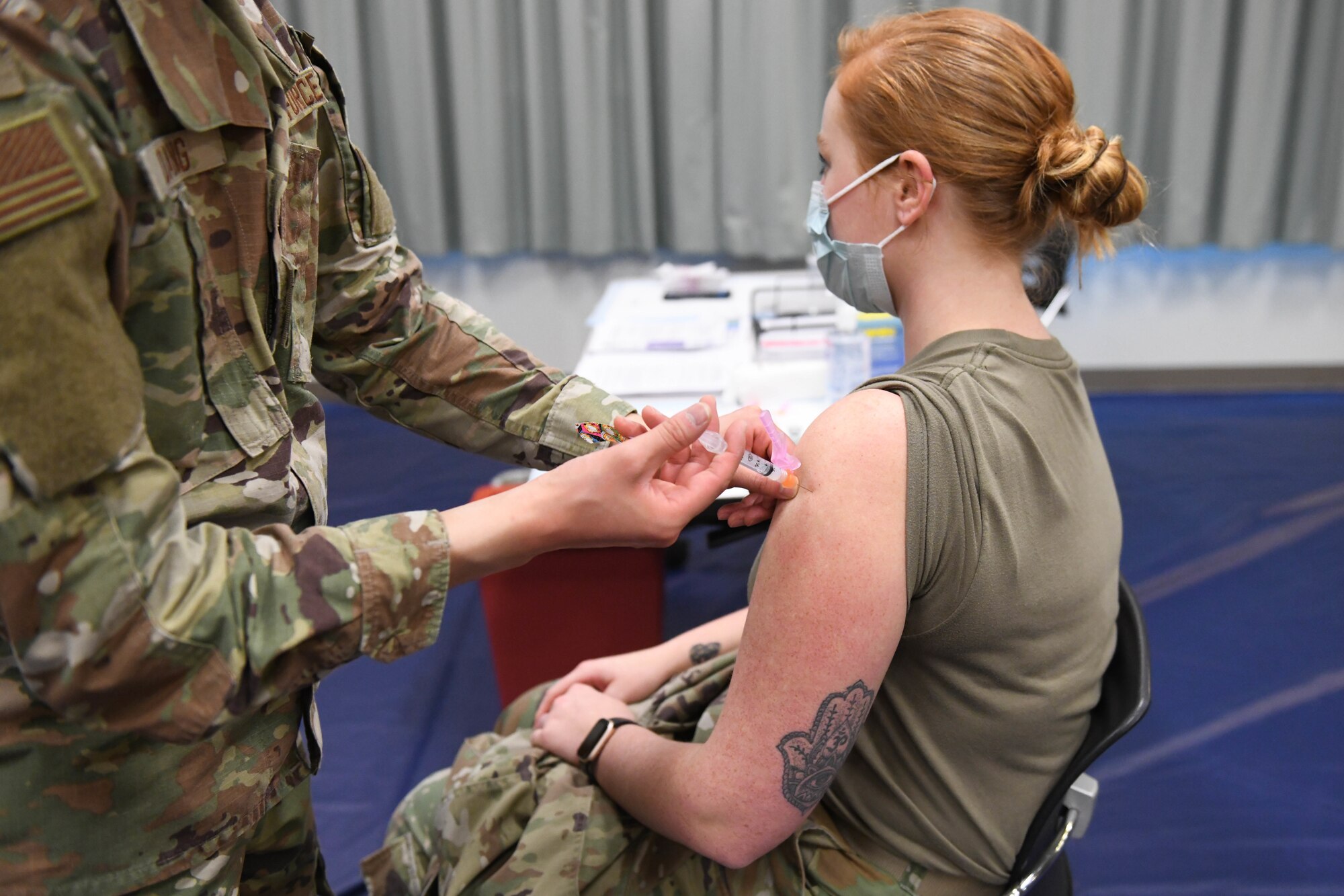 U.S. Air Force Tech. Sgt. David Hoang, an allergy and immunizations technician with the 18th Healthcare Operations Squadron, administers the Moderna’s vaccine to Senior Airman Julia Rodriguez, a laboratory technician with the 18th Medical Support Squadron at Kadena Air Base, Japan, Dec. 28, 2020. As part of DoD’s strategy for prioritizing, distributing and administering the COVID-19 vaccine, those providing direct medical care and emergency services will be prioritized to receive the vaccine at units based in Japan, including Kadena AB. (U.S. Air Force photo by Airman 1st Class Yosselin Perla)