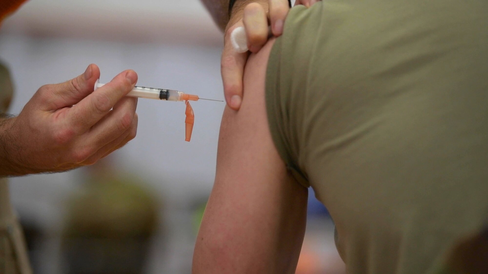 Red Cross volunteers and paramedics administer the Moderna COVID-19 vaccine to Team Kadena’s first-line defenders, Jan. 4, 2021, at Kadena Air Base, Japan. The COVID-19 vaccination plan is phase-driven and designed to safely protect members within the DoD as quickly as possible. (U.S. Air Force photo by Airman 1st Class Rebeckah Medeiros)
