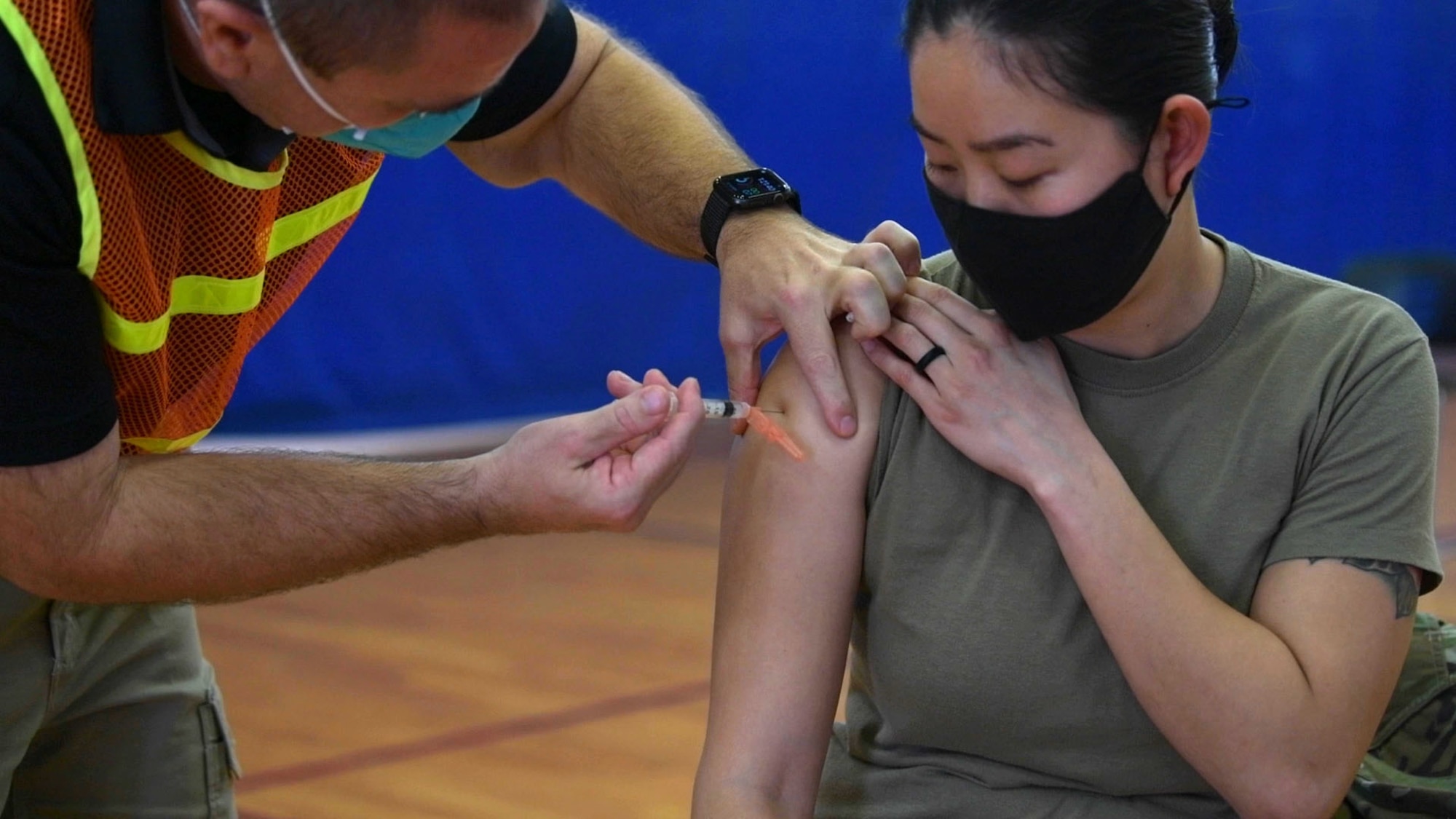 Red Cross volunteers and paramedics administer the Moderna COVID-19 vaccine to Team Kadena’s first-line defenders, Jan. 4, 2021, at Kadena Air Base, Japan. The COVID-19 vaccination plan is phase-driven and designed to safely protect members within the DoD as quickly as possible. (U.S. Air Force photo by Airman 1st Class Rebeckah Medeiros)