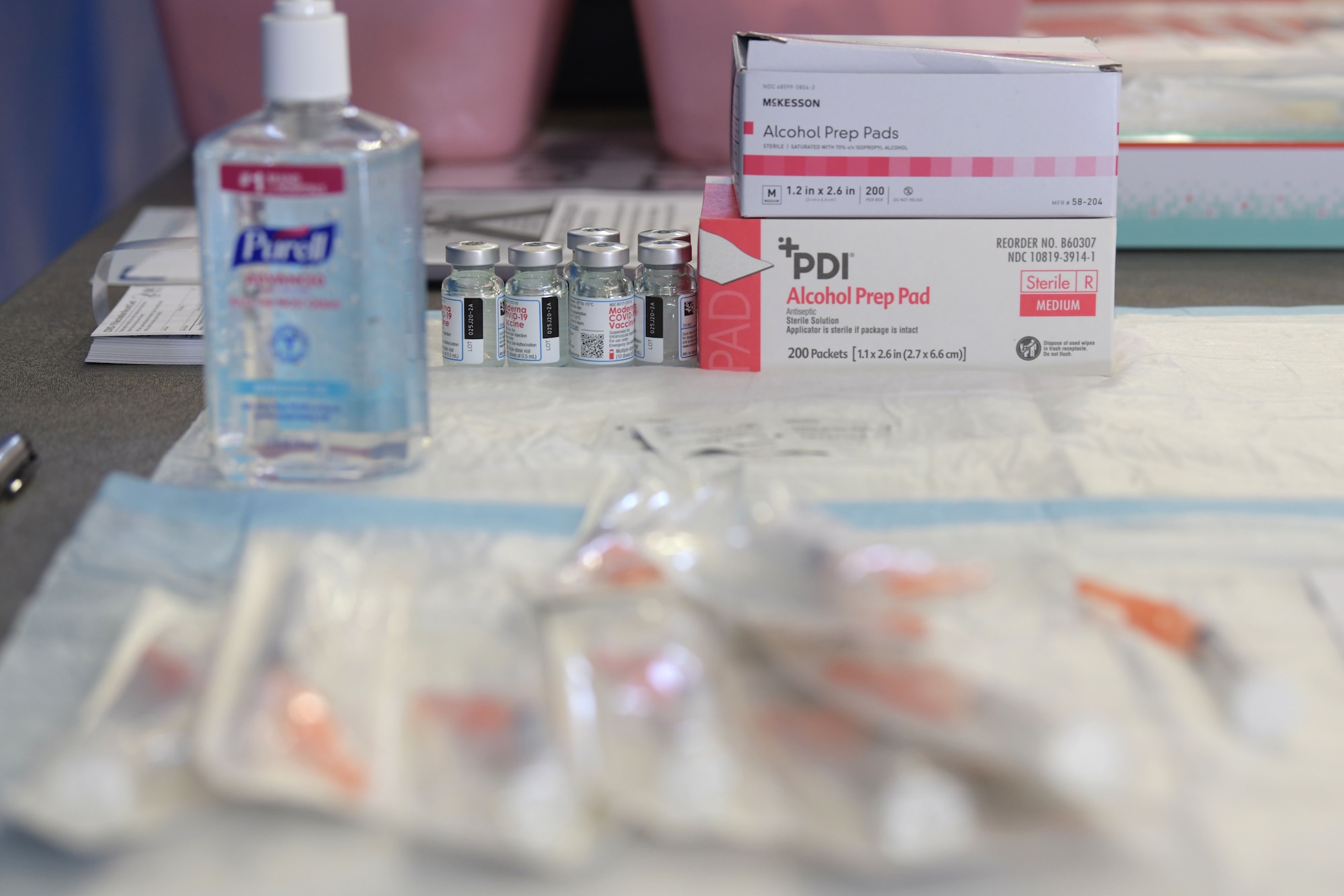 Syringes and vials of the Moderna COVID-19 Vaccine are spread across sanitized paper waiting administration, Jan. 4, 2021, at Kadena Air Base, Japan. As part of the DoD strategy for prioritizing, distributing and administering the COVID-19 vaccine, those providing direct medical care and emergency services will be prioritized to receive the vaccine at units based in Japan, including Kadena AB. (U.S. Air Force photo by Airman 1st Class Rebeckah Medeiros)