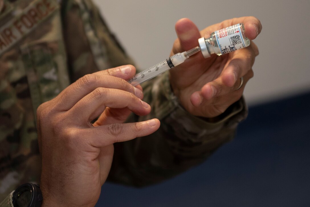 U.S. Air Force Senior Master Sgt. Shareef Cardwell, 52nd Medical Operations Squadron superintendent, fills a syringe during a COVID-19 vaccination disbursement Jan. 4, 2021, at Spangdahlem Air Base, Germany. Full effectiveness of the COVID-19 vaccine requires two doses beginning with the initial dose, and then following up with a second dose 28 days later. (U.S. Air Force photo by Senior Airman Melody W. Howley)