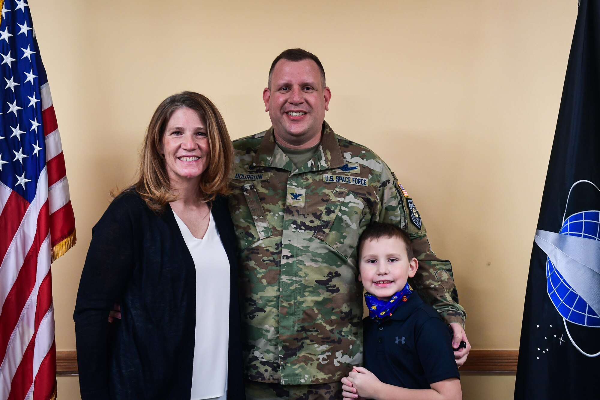 Col. Richard Bourquin, Space Delta 4 commander, his wife, Jodi, and his son, Bennett, pose for a family picture after Col. Bourquin commissioned into the U.S. Space Force, in the DEL 4 conference room at Buckley Air Force Base, Colo., Jan. 5, 2021.