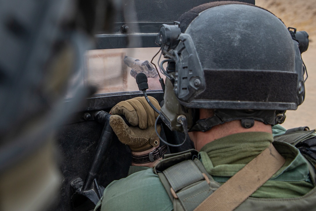 U.S. Marine Corps Lance Cpl. Cody Newhouse, shieldman, Special Reaction Team, Provost Marshall’s Office, Marine Air Ground Task Force Training Command, fires his M45A1 service pistol during an SRT familiarization range at Marine Corps Air Ground Combat Center, Twentynine Palms, California, Dec. 11, 2020. SRT Marines are military police officers trained in hostage situation, active shooter and barricaded suspect response. (U.S. Marine Corps photo by Lance Cpl. Joshua Sechser)