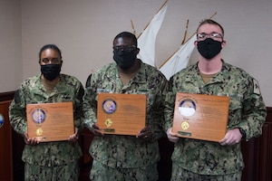 210105-N-IO414-1024 NAVAL SUPPORT ACTIVITY BAHRAIN (Jan. 5, 2021) Intelligence Specialist 1st Class Terrance Kirkland, center, Operations Specialist 2nd Class Nyesha Adams, left, and Yeoman 2nd Class Matthew Martin pose for a photo after being selected as U.S. Naval Forces Central Command’s (NAVCENT) Sailor of the Year, Junior Sailor of the Year and Bluejacket of the Year respectively. NAVCENT is the U.S. Navy element of U.S. Central Command in the U.S. 5th Fleet area of operations, which encompasses about 2.5 million square miles of water area and includes the Arabian Gulf, Gulf of Oman, Red Sea and parts of the Indian Ocean. The expanse is comprised of 20 countries and includes three critical choke points at the Strait of Hormuz, the Suez Canal and the Strait of Bab al Mandeb at the southern tip of Yemen.