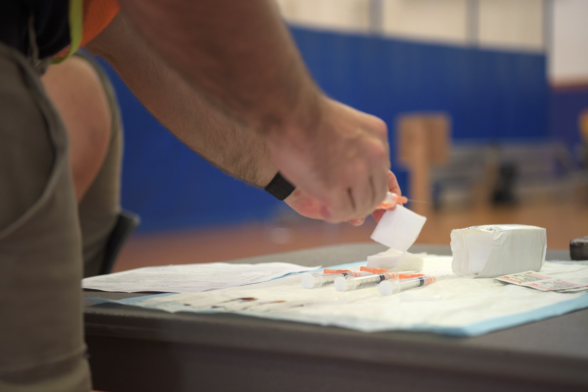 A Red Cross volunteer prepares syringes containing the Moderna COVID-19 vaccine at Kadena Air Base, Japan, Jan. 4, 2021. As part of DoD strategy for prioritizing, distributing and administering the COVID-19 vaccine, those providing direct medical care and emergency services will be prioritized to receive the vaccine at units based in Japan, including Kadena AB. (U.S. Air Force photo by Airman 1st Class Anna Nolte)