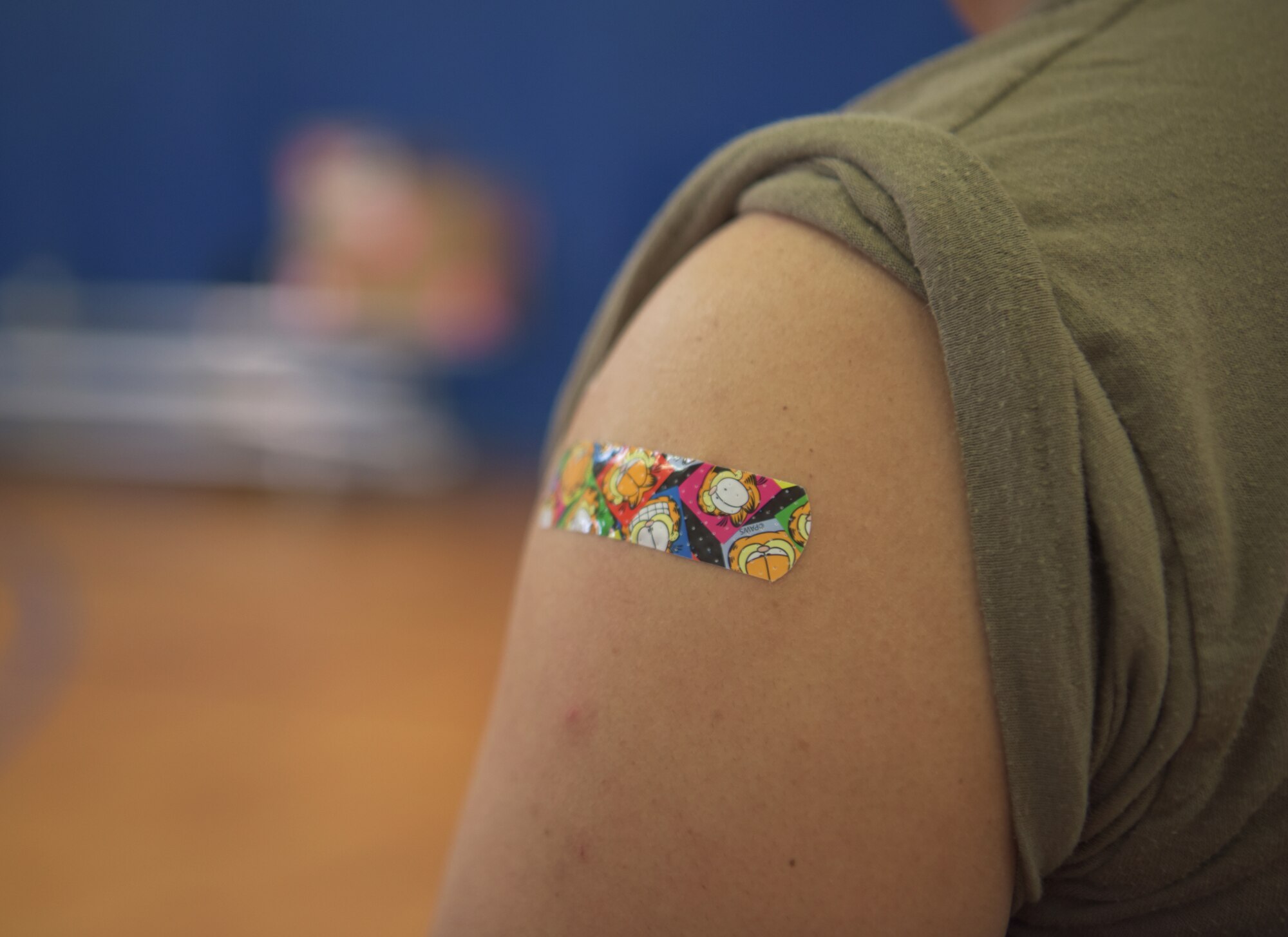 A Band-Aid protects the injection site after a patient receives the Moderna COVID-19 vaccination at Kadena Air Base, Japan, Jan. 4, 2021. As part of the DoD strategy for prioritizing, distributing and administering the COVID-19 vaccine, those providing direct medical care and emergency services will be prioritized to receive the vaccine at units based in Japan, including Kadena AB. (U.S. Air Force photo by Airman 1st Class Anna Nolte)