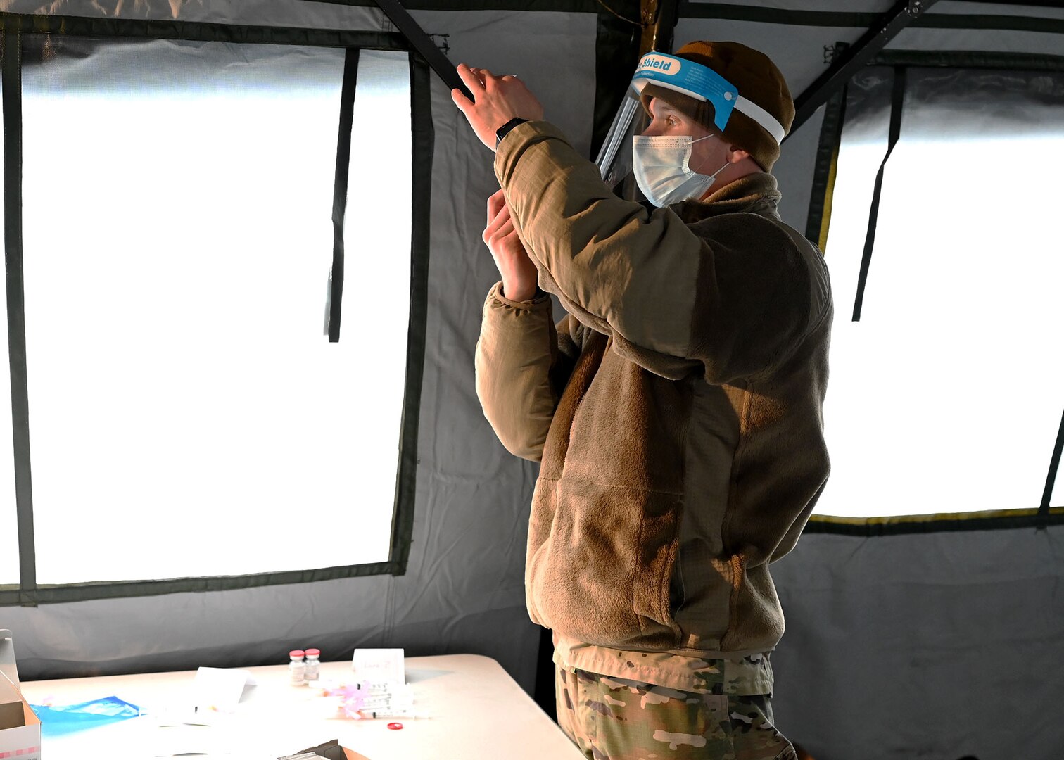 Staff Sgt. Mark Kucal, a medical technician with the 157th Air Refueling Wing, NHANG, draws Moderna COVID-19 vaccine into a syringe at a vaccination site in Lebanon, N.H. on Jan. 5, 2021.