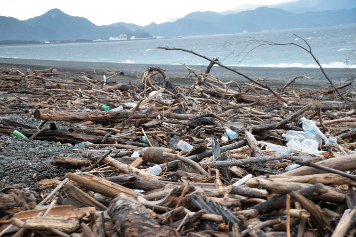 Combined Arms Training Center Camp Fuji Marines and Sailors clean up trash and ocean debris from Numazu Beach Training Area, Shizuoka, Japan, Dec. 30, 2020. Service members cleared over 2700 liters of trash and other ocean debris from the beach, which is used by joint U.S. forces and the Japan Maritime Self Defense Force for air ground and amphibious training.