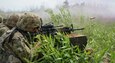 Soldiers from 1st battalion, 109th Infantry Regiment, 2nd Infantry Brigade Combat Team, 28th Infantry Division, work together to move across a course during combined arms live fire training on July 30, 2020, at Fort Indiantown Gap, Pa. Utilizing radio, hand signals, smoke, and more, the leadership of the Soldiers communicated effectively to cross the course while engaging targets.