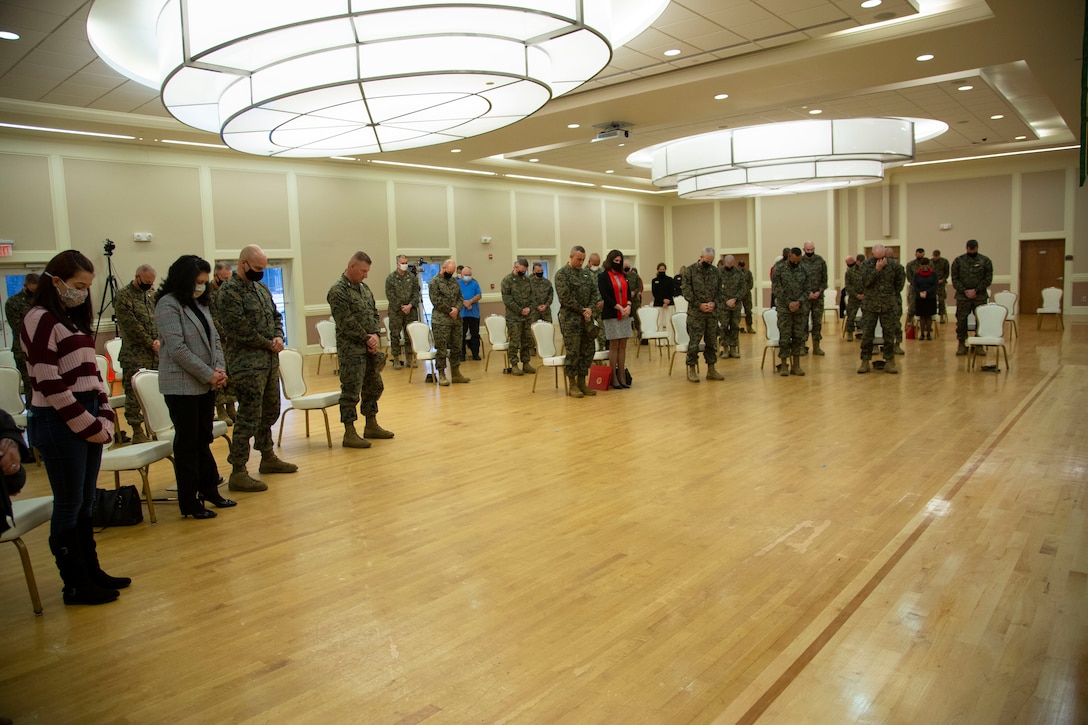 U.S. Marines and civilians bow their heads during the invocation before the relief and appointment ceremony for Marine Corps Installations East-Marine Corps Base Camp Lejeune at the Marston Pavilion on MCB Camp Lejeune, North Carolina, Dec. 21, 2020. Sgt. Maj. Charles A. Metzger, outgoing sergeant major for MCIEAST-MCB Camp Lejeune, relinquished his duties to Sgt. Maj. Robert M. Tellez and retired after 30 years of honorable service to the Marine Corps. (U.S. Marine Corps photo by Cpl. Ginnie Lee)