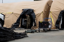 JOINT BASE LANGLEY-EUSTIS, Va. (January 6, 2021) U.S. Army Maj. Gwendolyn Bamford, assigned to Joint Task Force Civil Support’s J5 department, carries a table out of a command post tent at the conclusion of an equipment check in preparation for the command’s upcoming exercise Sudden Response 21.