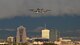 a photo of an A-10 Thunderbolt II flying with a view of a city skyline in the background