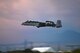 photo of an A-10 Thunderbolt II taking off from a military base flightline.