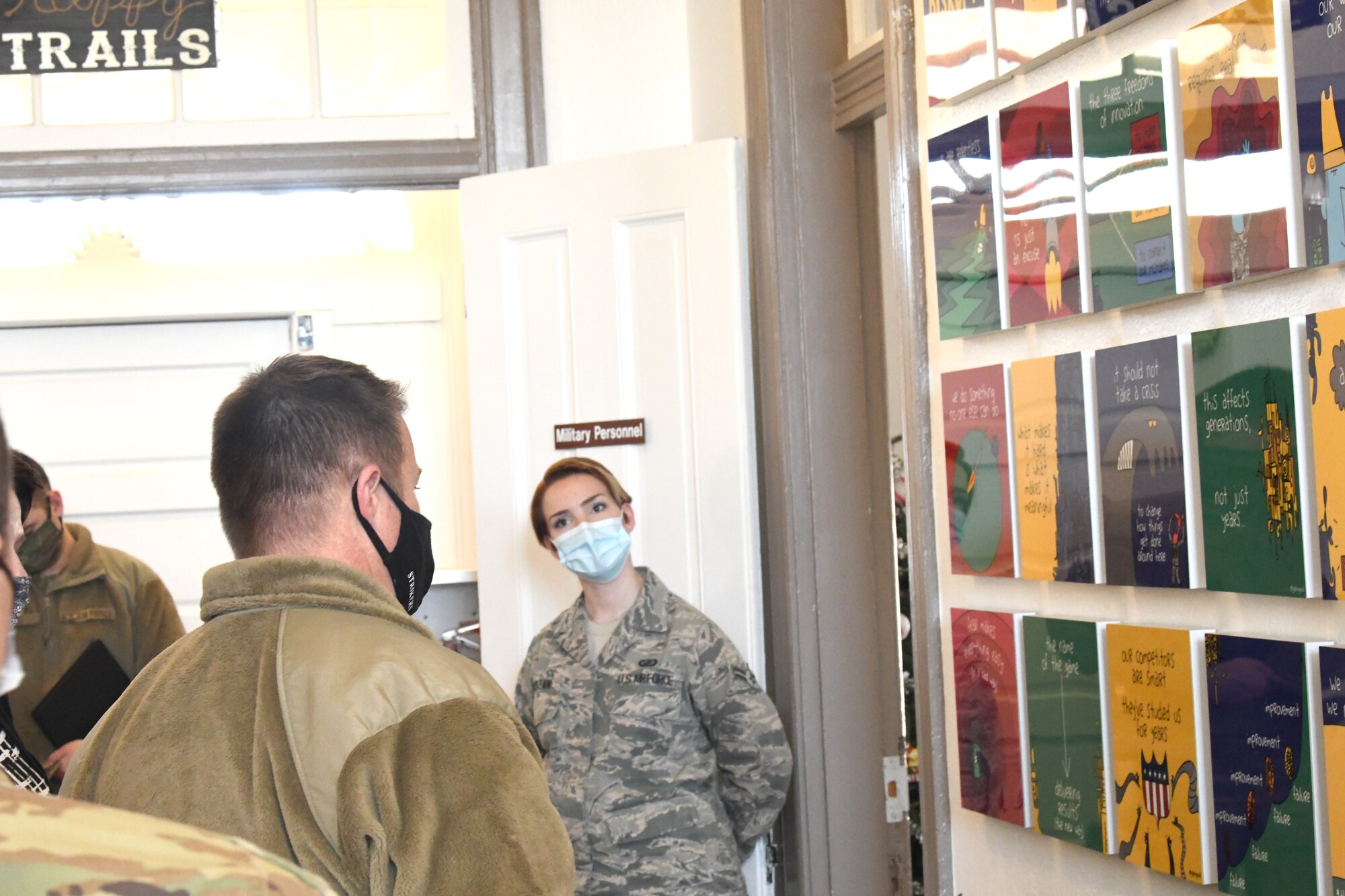 Airman shows Chief Hoffman culture wall