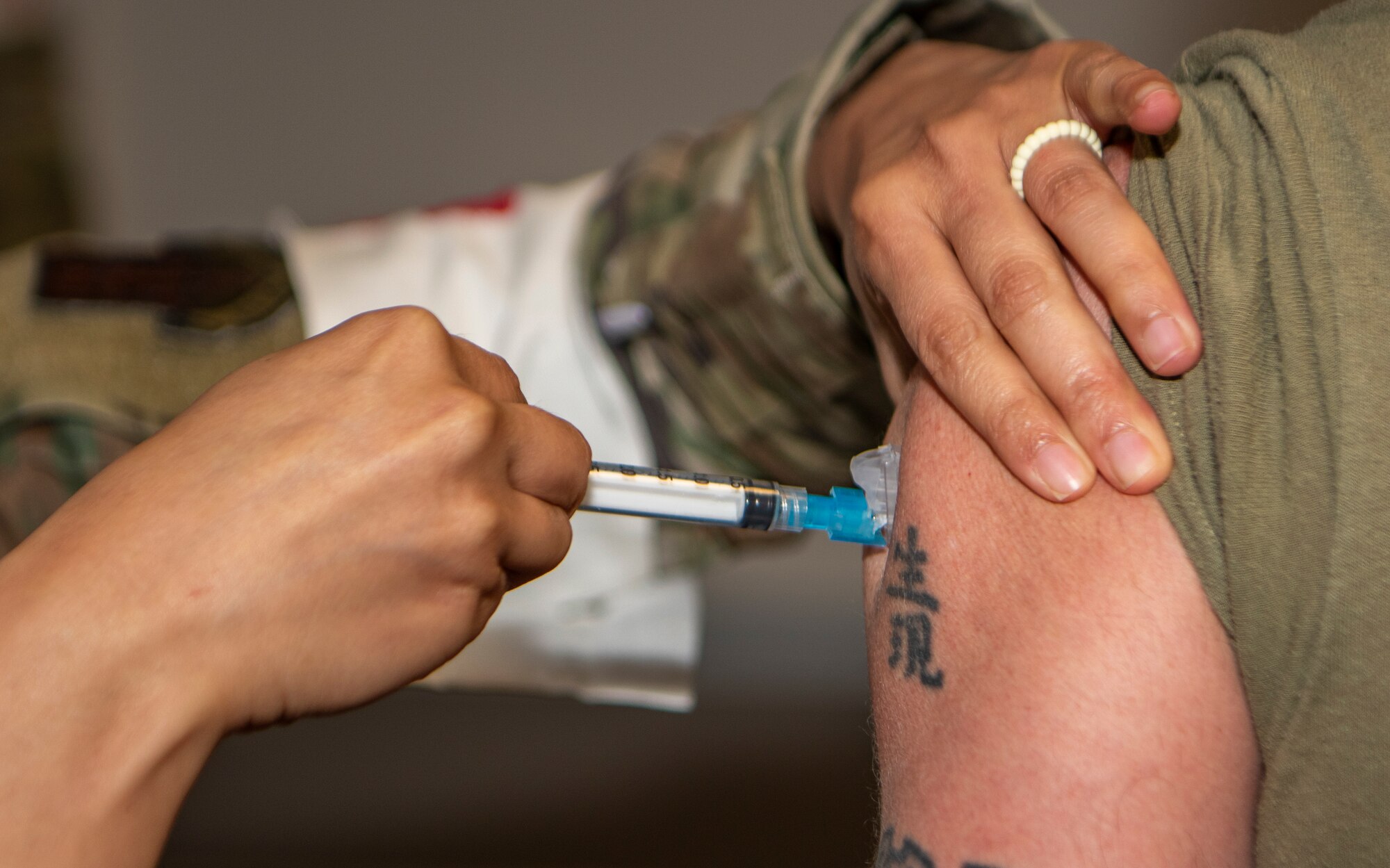 Airman receives a shot in the arm.
