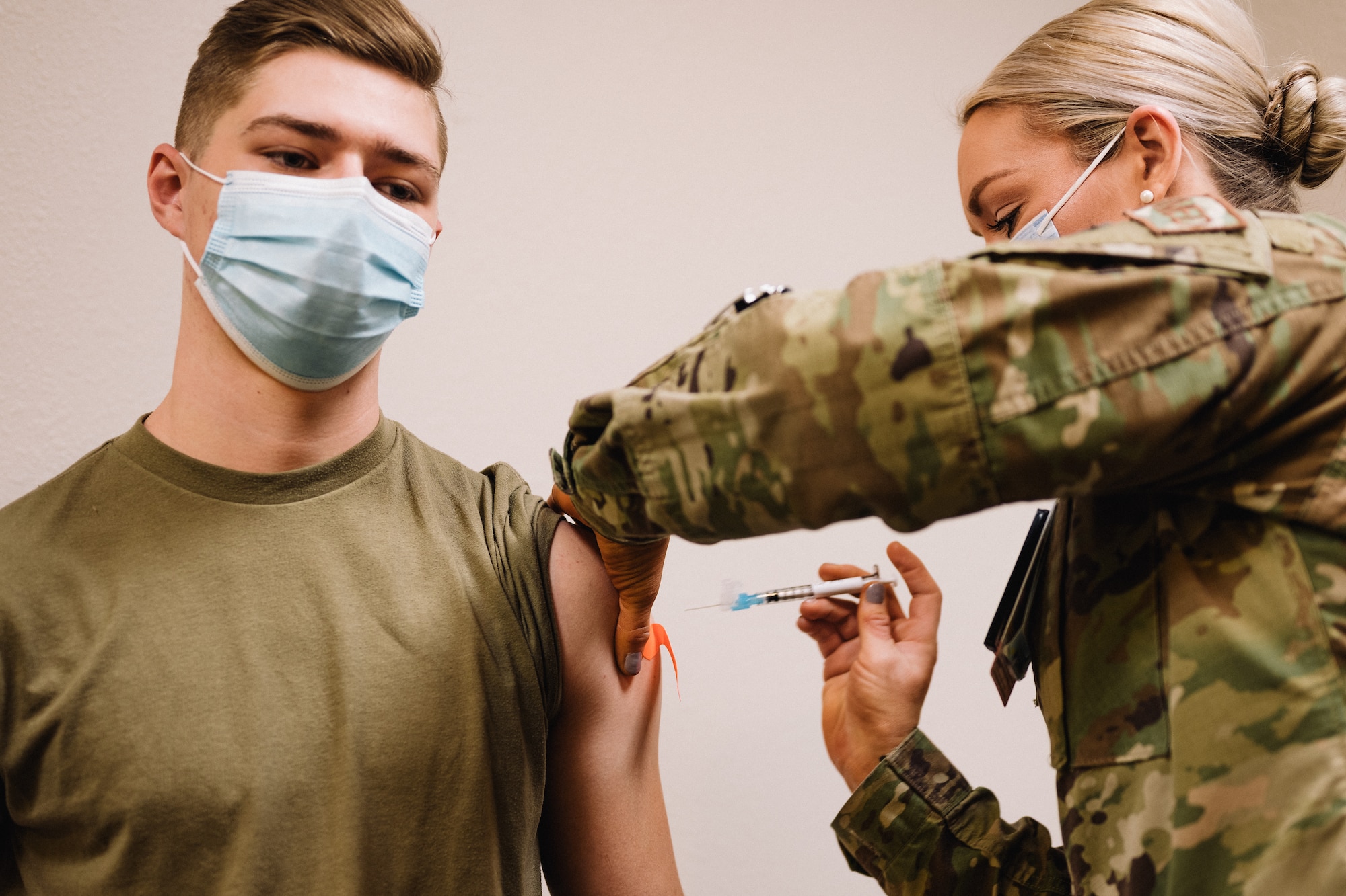 Airman 1st Class James Gehne, 375th Civil Engineer Squadron firefighter, receives the first COVID-19 inoculation on Scott Air Force Base, Ill., Jan 6, 2021. Vaccines combating COVID-19 use inactivated virus genetics to strengthen the immunity properties of the receiver while still making it impossible to contract COVID-19 from the inoculation. (U.S. Air Force photo by Tech. Sgt. Jordan Castelan)