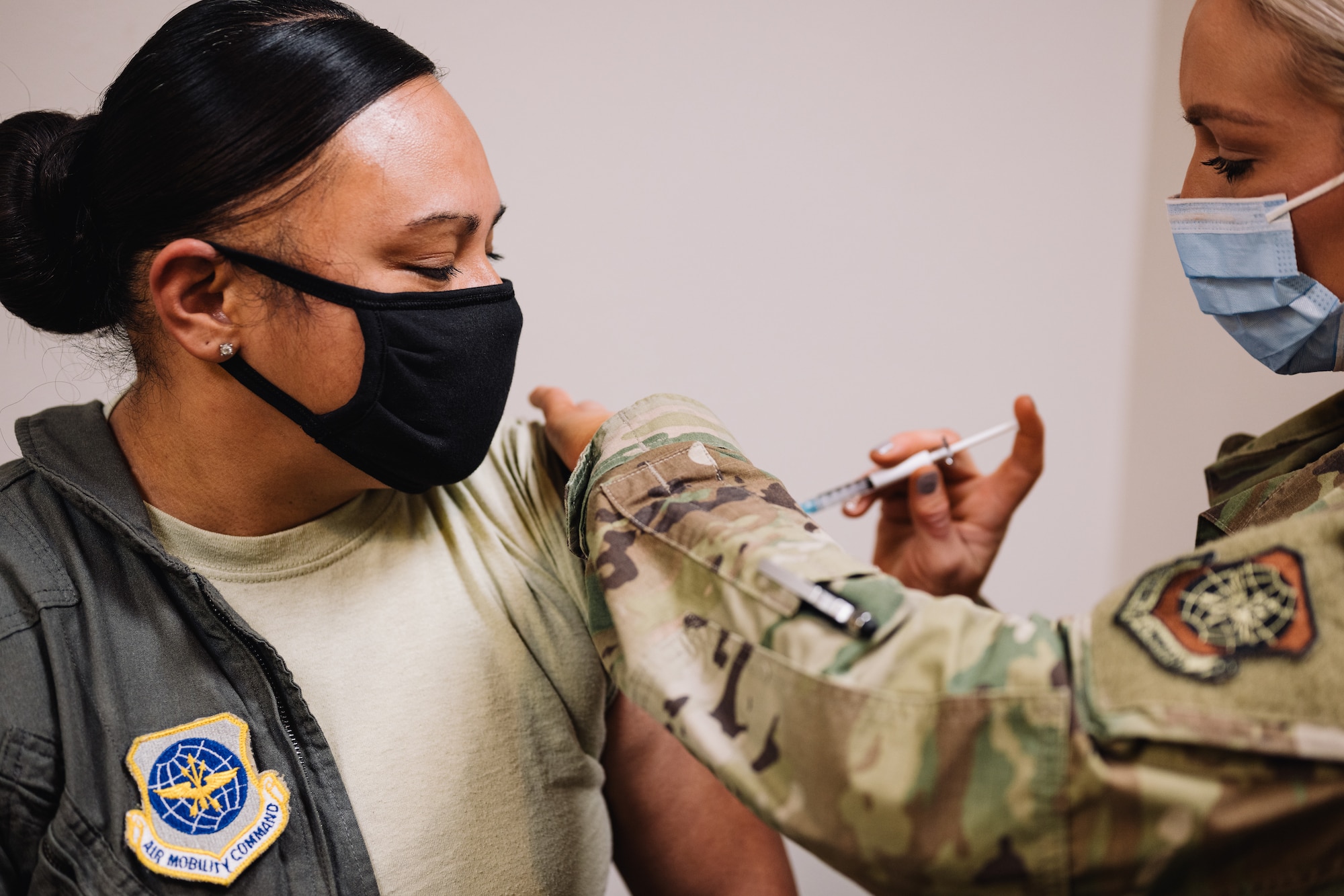Master Sgt. Renee Cheatham, 375th Aeromedical Evacuation Squadron aeromedical evacuation technician, receives one the first COVID-19 inoculations on Scott Air Force Base, Ill., Jan 6, 2021. The COVID-19 vaccines will be available on a voluntary basis in which early vaccination participation is highly encouraged for priority personnel; masks and physical distancing will still be necessary until a large proportion of the population is vaccinated and the vaccine is proven to provide long-term protection. (U.S. Air Force photo by Tech. Sgt. Jordan Castelan)