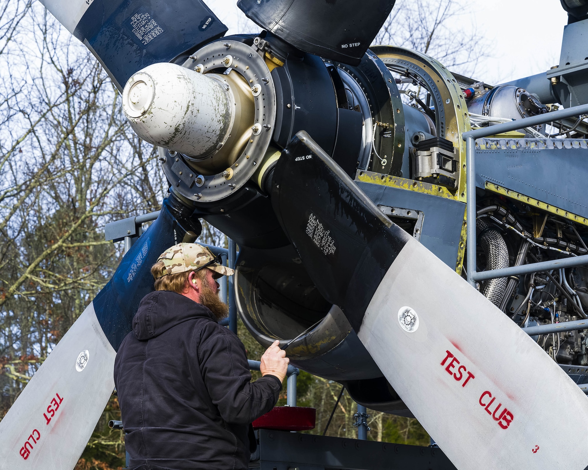 Todd Jobst, Contract Field Team member, inspects the air intake of a newly upgraded T-56 Rolls Royce 3.5 modified engine on Jan. 4, 2021, at Little Rock Air Force Base, Ark. An operational check out of all engine and propeller systems are performed, to ensure the systems meet performance specifications before delivery to an Air Force Reserve or Air National Guard C-130H Hercules squadron. Contracted mechanics at the engine test cell facility ensure each engine is serviceable, troubleshoots any issues, and performs additional inspections. (U.S. Air Force Reserve photo by Maj. Ashley Walker)