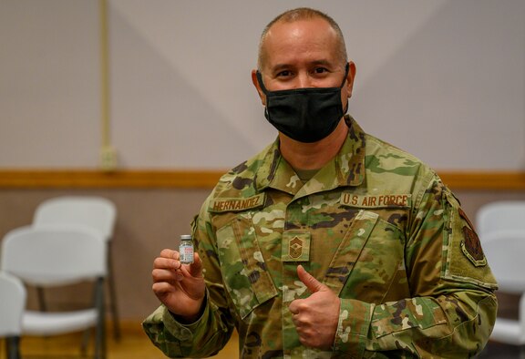Airman poses with vile in his hand