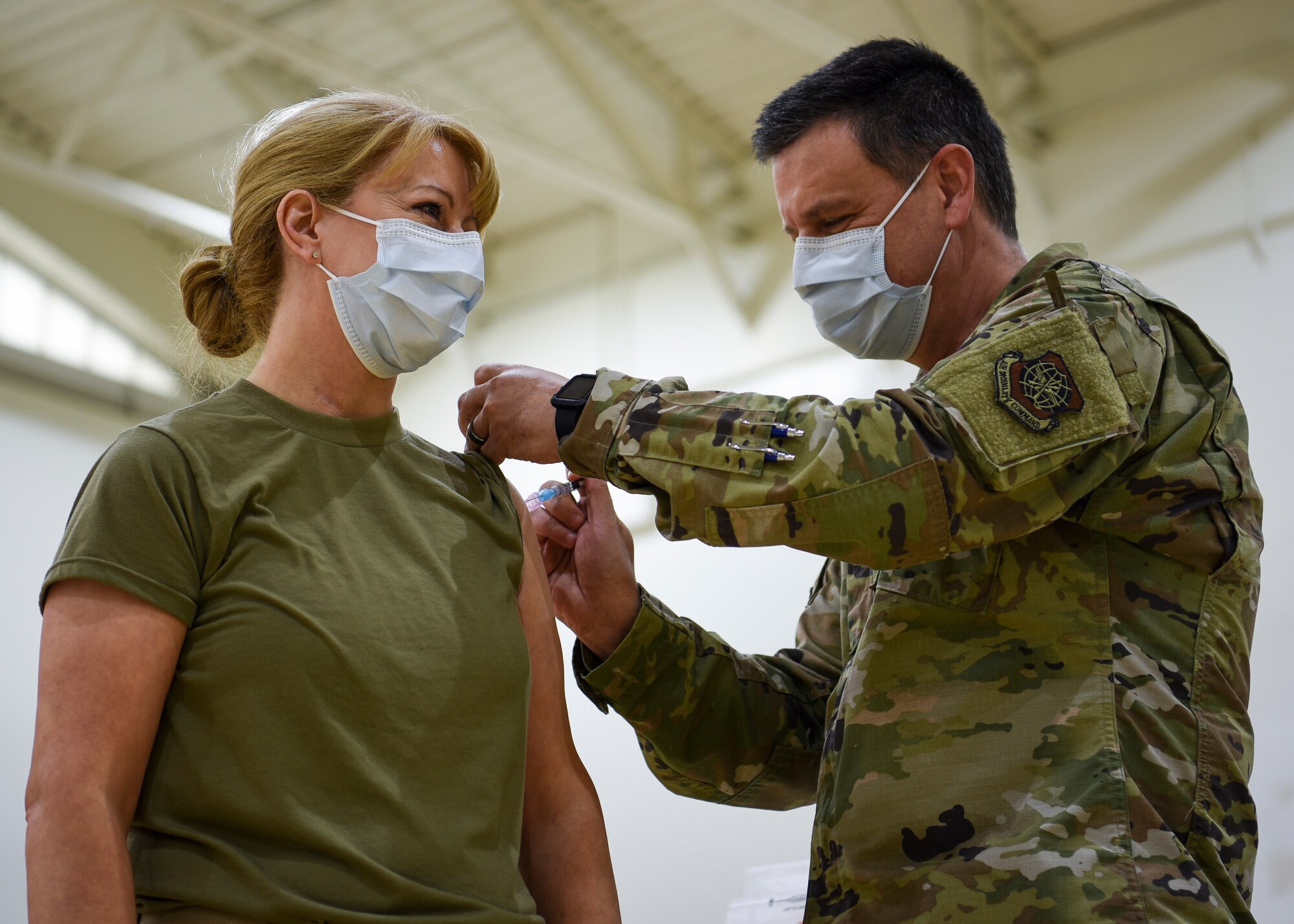 Maj. Dayla Gillispie, 87th Medical Group Family Health Clinic flight commander, receives the first COVID-19 vaccination on Joint Base McGuire-Dix-Lakehurst, New Jersey, from her husband, Lt. Col. Timothy Gillispie, 87th MDG Warrior Clinic flight commander, Dec. 31, 2020. Gillispie said receiving the vaccine was an honor and the next step to eliminating COVID-19. (U.S. Air Force photo by Senior Airman Shay Stuart)