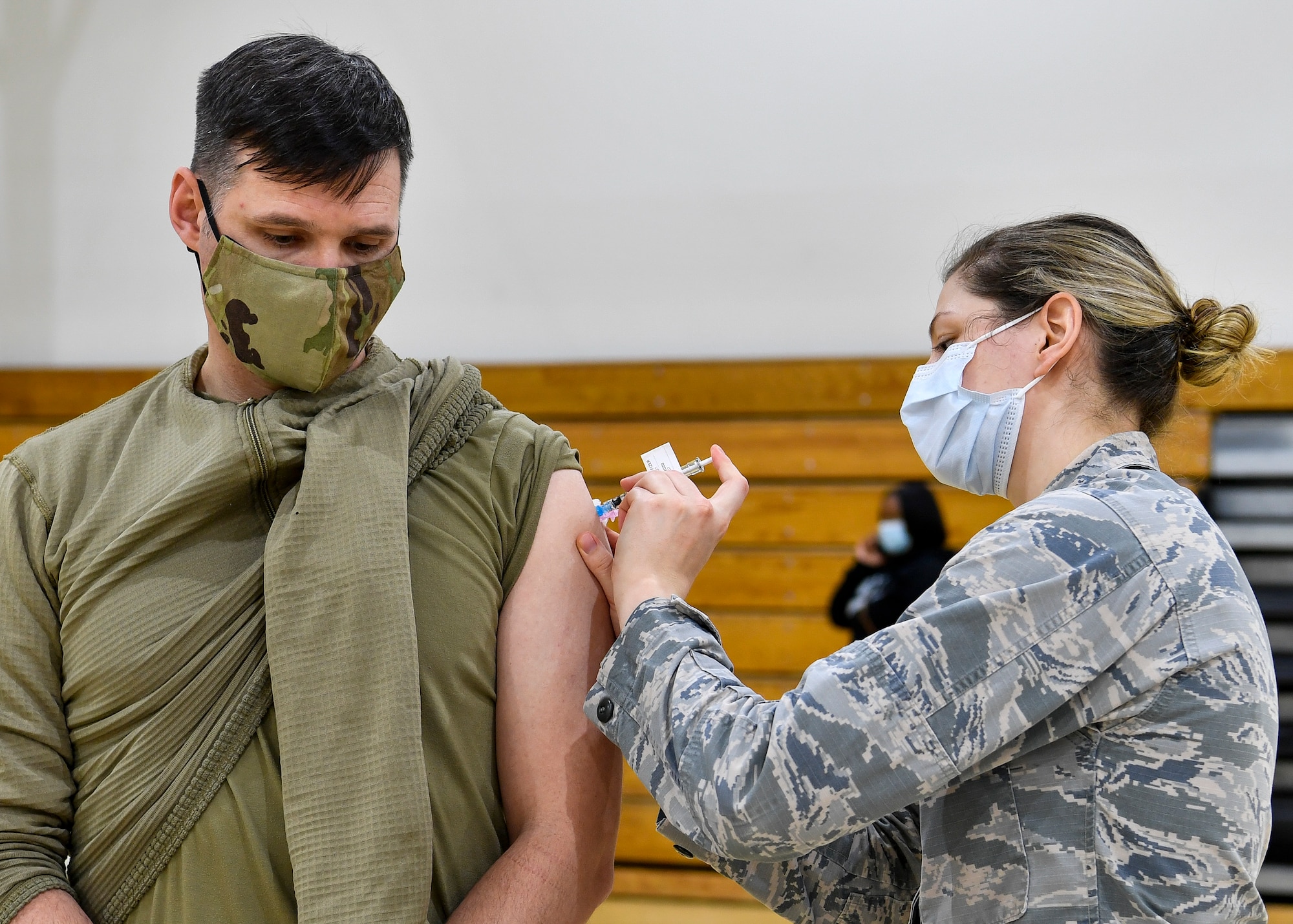 Chief Master Sgt. Spence Johnson, 87th Security Forces Squadron superintendent, receives the COVID-19 vaccine at the Point of Dispensing on Joint Base McGuire-Dix-Lakehurst, New Jersey, Dec. 31, 2020. In accordance with the Department of Defense vaccination plan, the 87th Medical Group prioritized medical care providers, emergency services, safety personnel, and deploying forces to receive the vaccine before other members of the DoD population. (U.S. Air Force photo by Staff Sgt. Jake Carter)