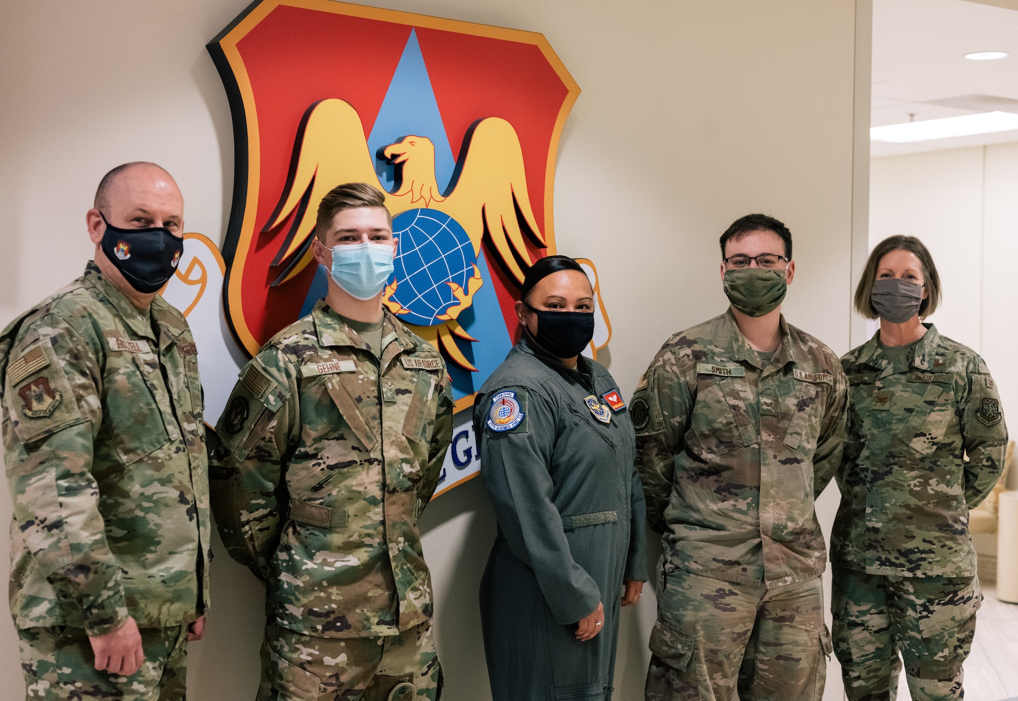 Airman 1st Class James Gehne, 375th Civil Engineer Squadron firefighter, second from the left, Master Sgt. Renee Cheatham, 375th Aeromedical Evacuation Squadron aeromedical evacuation technician, middle, and Senior Airman Matthew Smith, 375th Security Forces patrolman, second from the right, are congratulated by Chief Master Sgt. Chuck Frizzell, 375th Air Mobility Wing command chief, left, and Col. Angela Ochoa, 375th AMW vice-commander, right, for being the first three members of Team Scott to receive a COVID-19 inoculation on Scott Air Force Base, Ill., Jan 6, 2021. The Department of Defense prioritizes personnel to receive the vaccines based on Center of Disease Control guidance and the DoD COVID Task Force’s assessment of unique DoD mission requirements. The DoD Prioritization Schema prioritizes those providing direct medical care, maintaining essential national security and installation functions, deploying forces and beneficiaries at the highest risk for developing serious illness before other members of the DoD population. (U.S. Air Force photo by Tech. Sgt. Jordan Castelan)