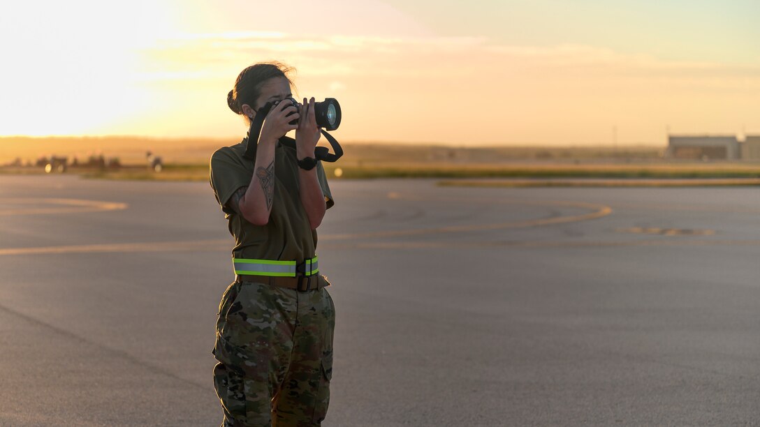 Senior Airman Tristan Day, 341st Missile Wing photojournalist, photographs Bomber Task Force mission operations, at Andersen Air Force Base, Guam, Dec. 15, 2020. As a photojournalist, Day captures the U.S. Air Force mission in the form of written words, photos and videos. (U.S. Air Force photo by Airman 1st Class Austin McIntosh)