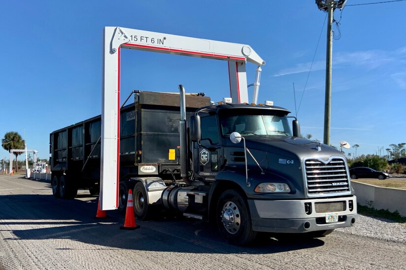 A large truck is driven through a three-sided x-ray system.