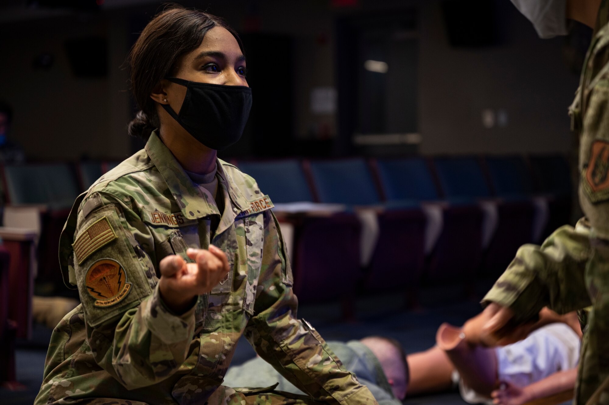 Senior Airman Jordan Jennings, 911th Aeromedical Staging Squadron medical technician, explains the next step in the process of administering medical aid to an assessor during an exercise at the Pittsburgh International Airport Air Reserve Station, Pennsylvania, Dec. 9, 2020.