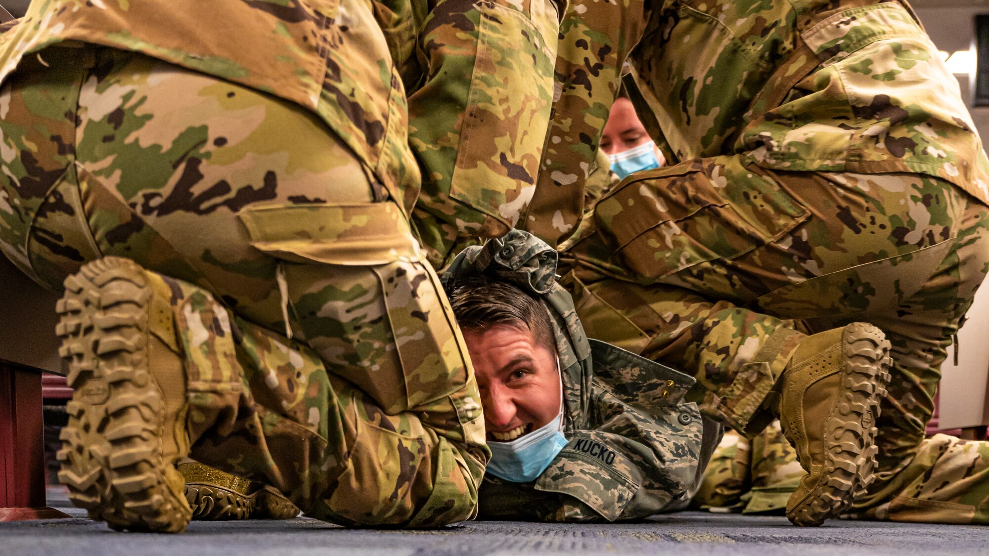 Airmen assigned to the 911th Aeromedical Staging Squadron restrain a simulated patient during an exercise at the Pittsburgh International Airport Air Reserve Station, Pennsylvania, Dec. 9, 2020.