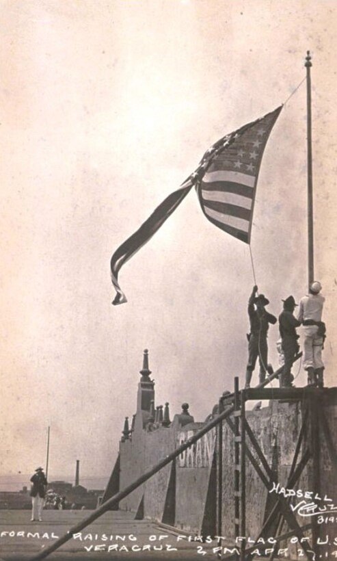 Formal raising
of first U.S. flag
in Veracruz, Mexico,
on April 27, 1914,
by Sailors and Marines
of USS Utah and
USS Florida. Then-
GySgt Clark and his
fellow leathernecks
were withdrawn from
Mexico later that year.