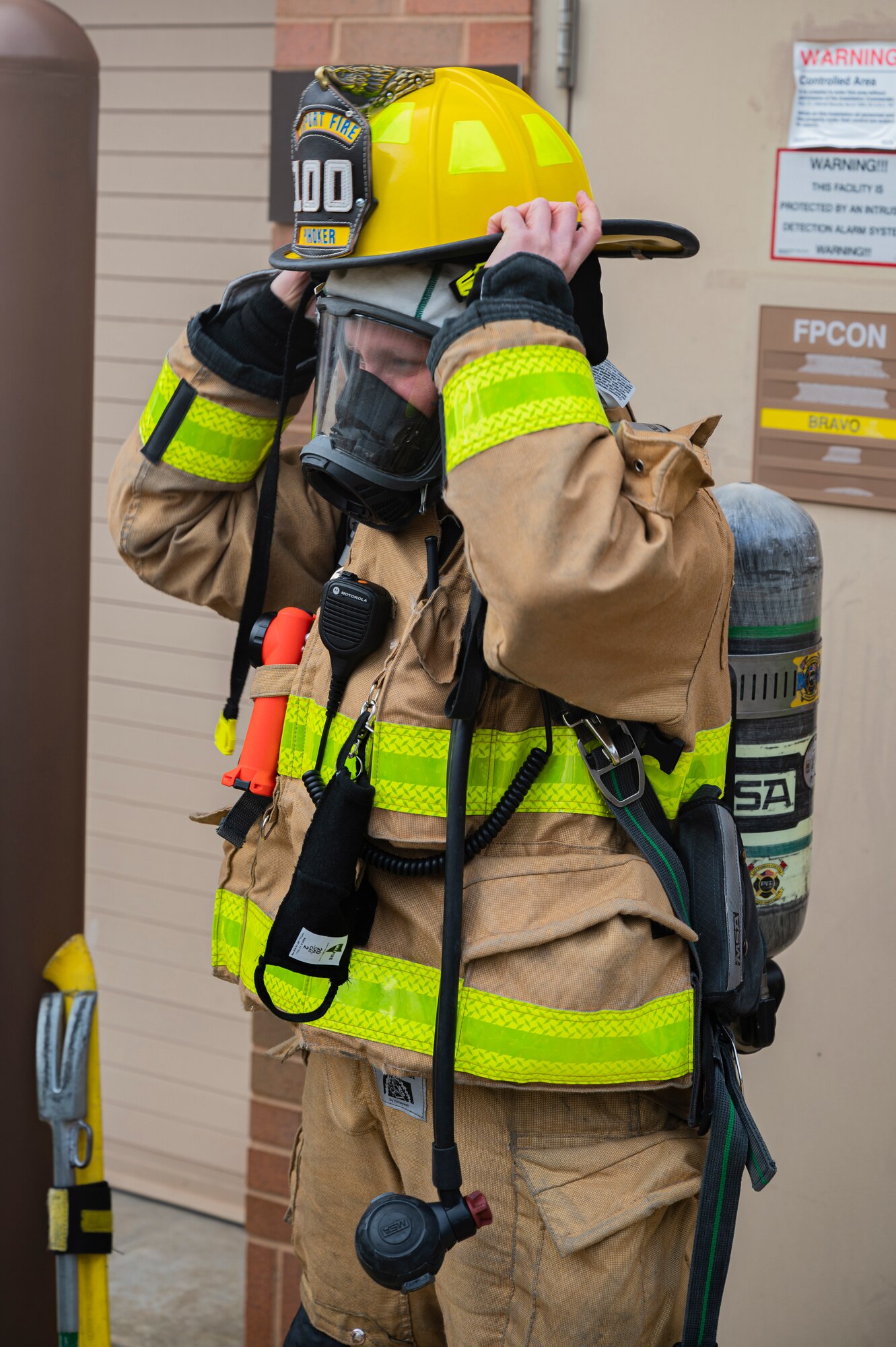 Alexis Pihoker, Allegheny County Airport Authority firefighter, dons her protective gear to enter a munitions storage area during a fire drill at the Pittsburgh International Airport Air Reserve Station, Pennsylvania, Dec. 10, 2020.