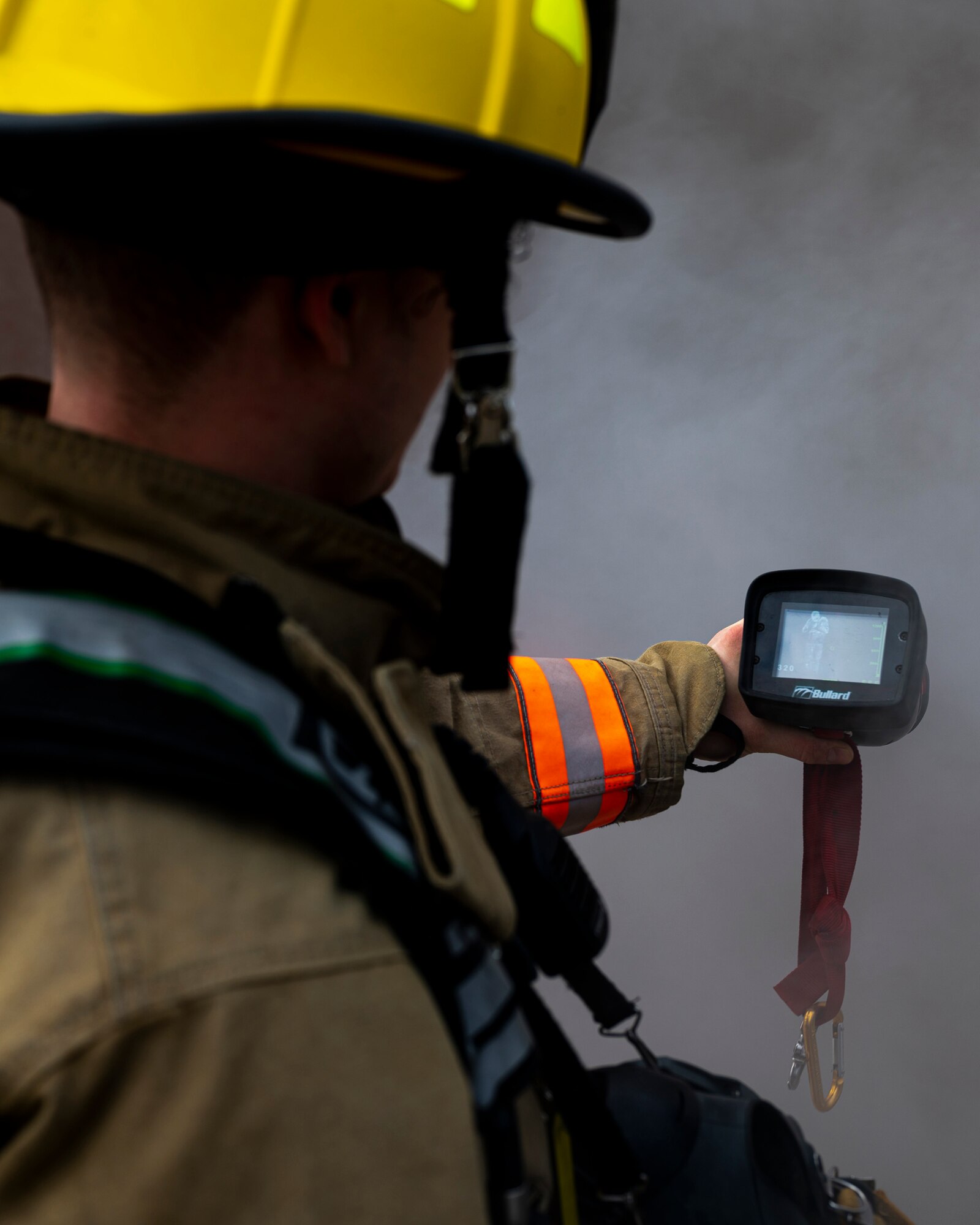 Adam Zelenko, Allegheny County Airport Authority firefighter, uses a thermal camera to identify people in a smoke-filled munitions storage area during a fire drill at the Pittsburgh International Airport Air Reserve Station, Pennsylvania, Dec. 10, 2020.